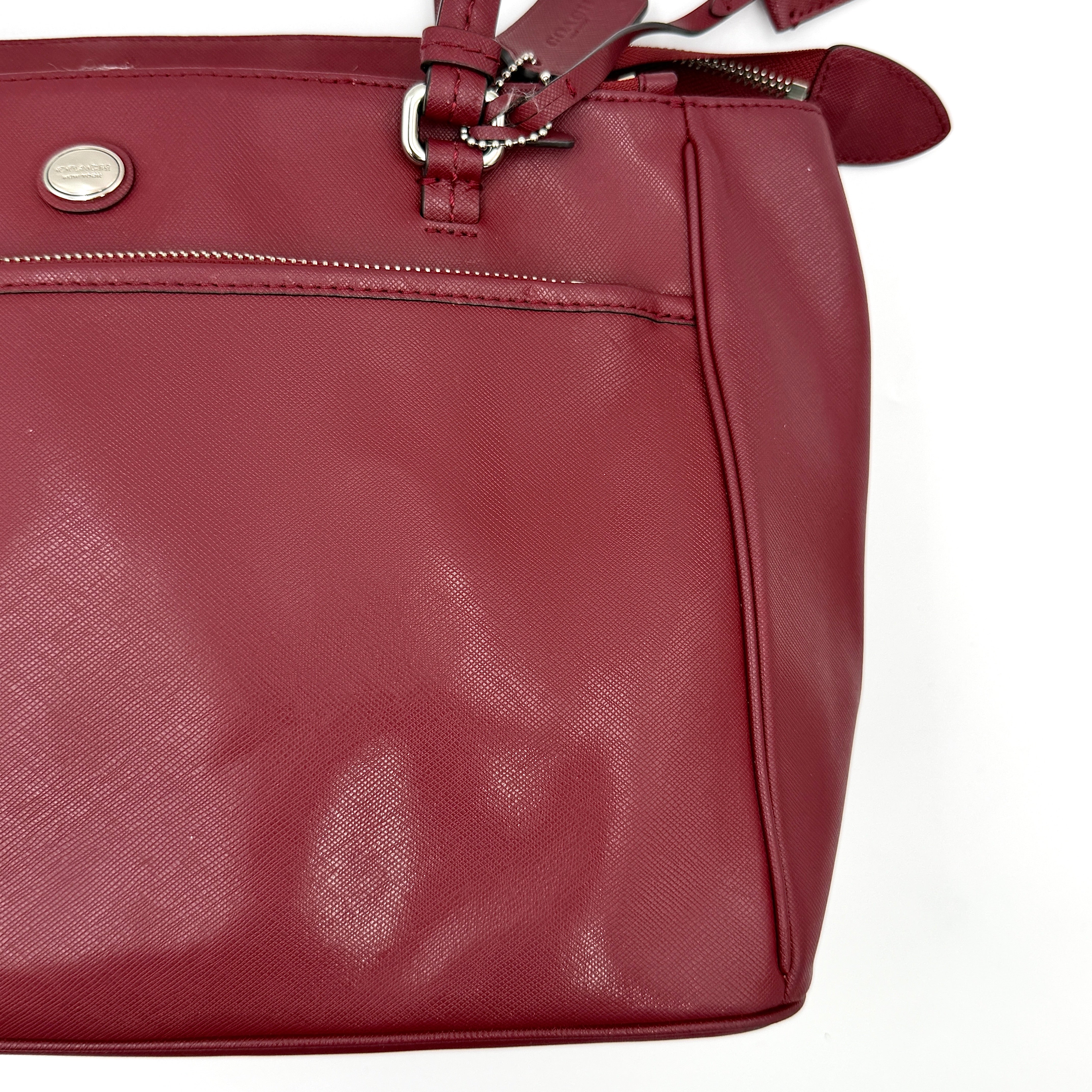 Coach 2Way Peyton Carryall Shoulder Bag in maroon leather with silver hardware, top handles, and detachable strap styled beside the bag.