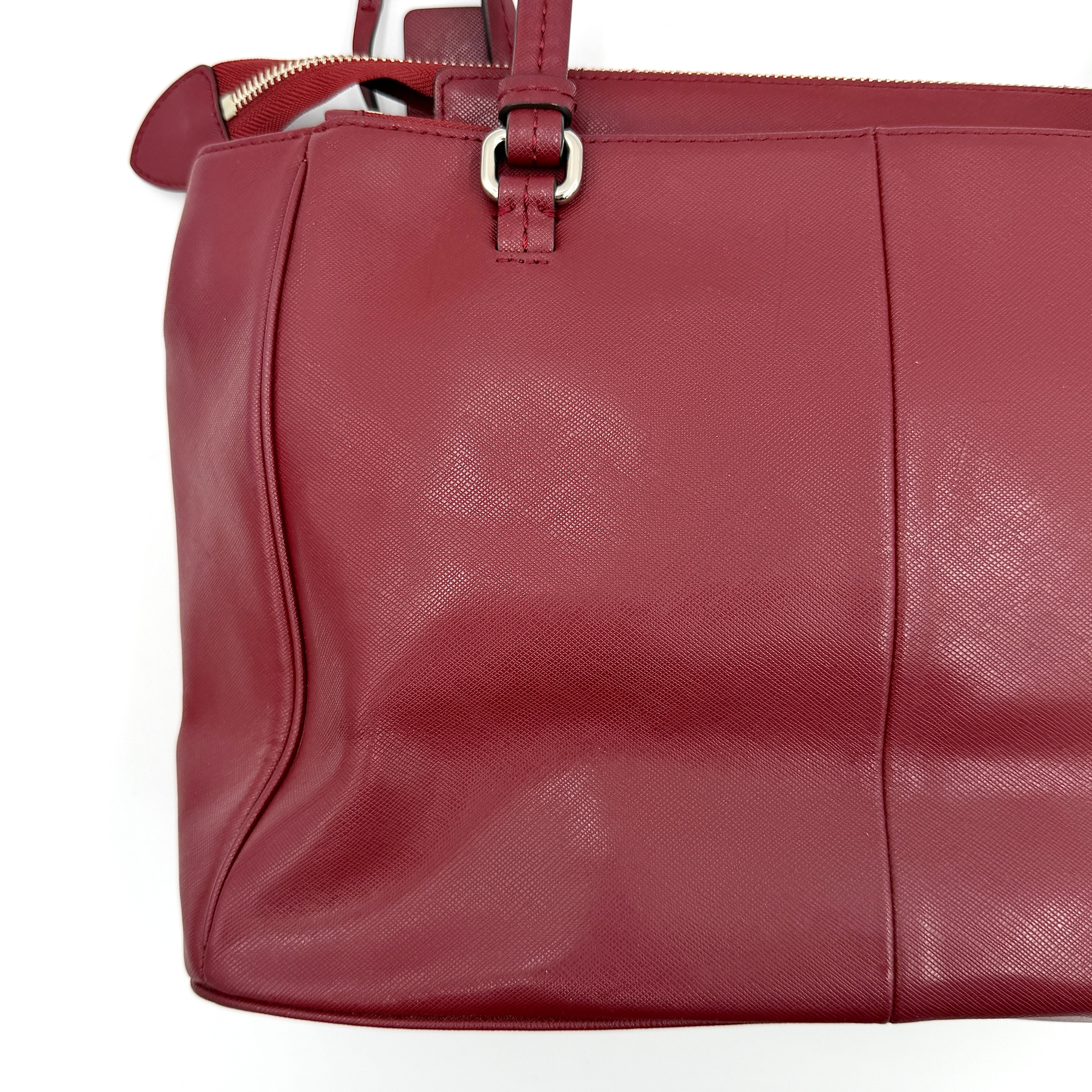 Coach 2Way Peyton Carryall Shoulder Bag in maroon leather with silver hardware, top handles, and detachable strap styled beside the bag.