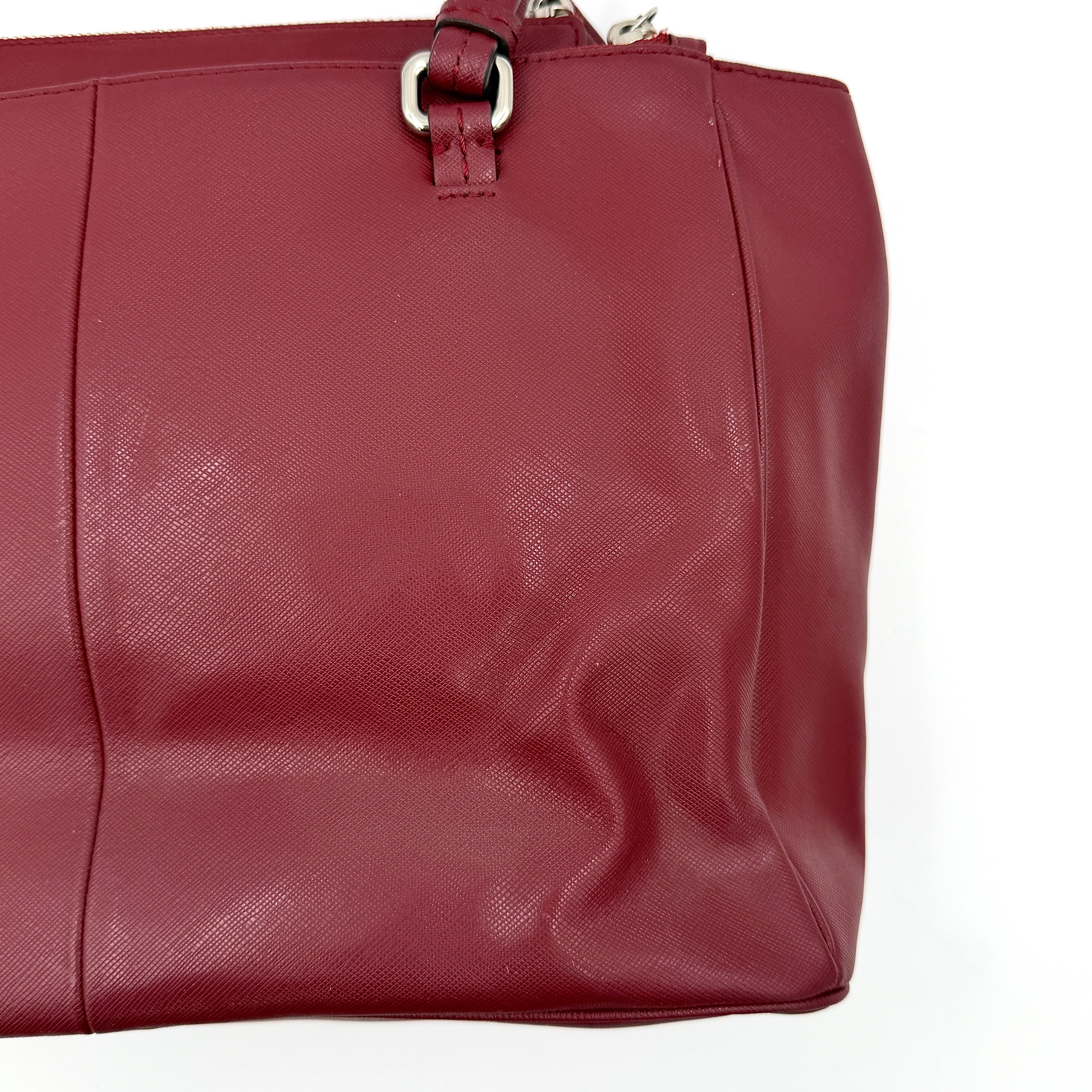 Coach 2Way Peyton Carryall Shoulder Bag in maroon leather with silver hardware, top handles, and detachable strap styled beside the bag.