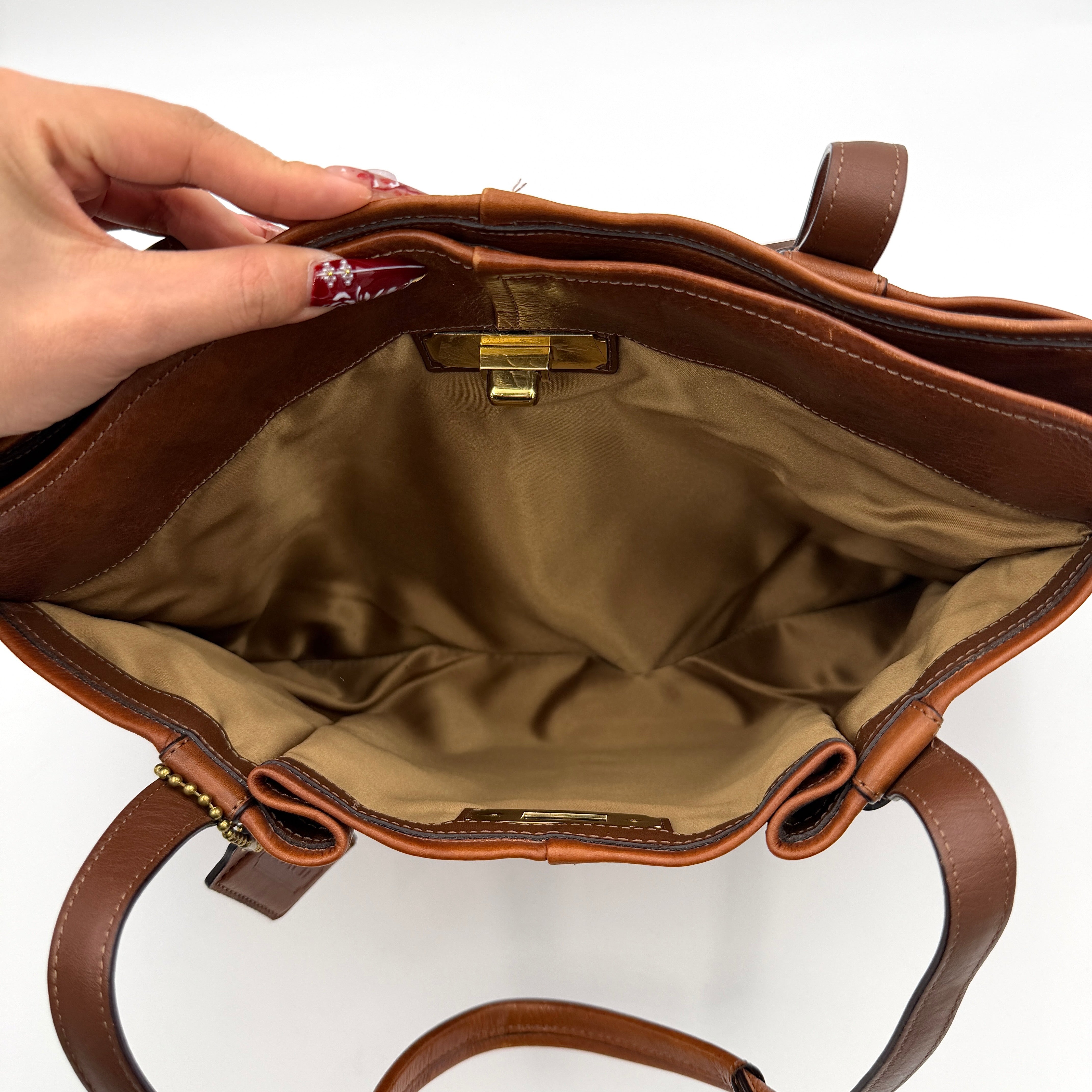 Coach Chelsea Jayden Shoulder Bag in rich brown grained leather, with gold-tone turn-lock and subtle pleated detailing.