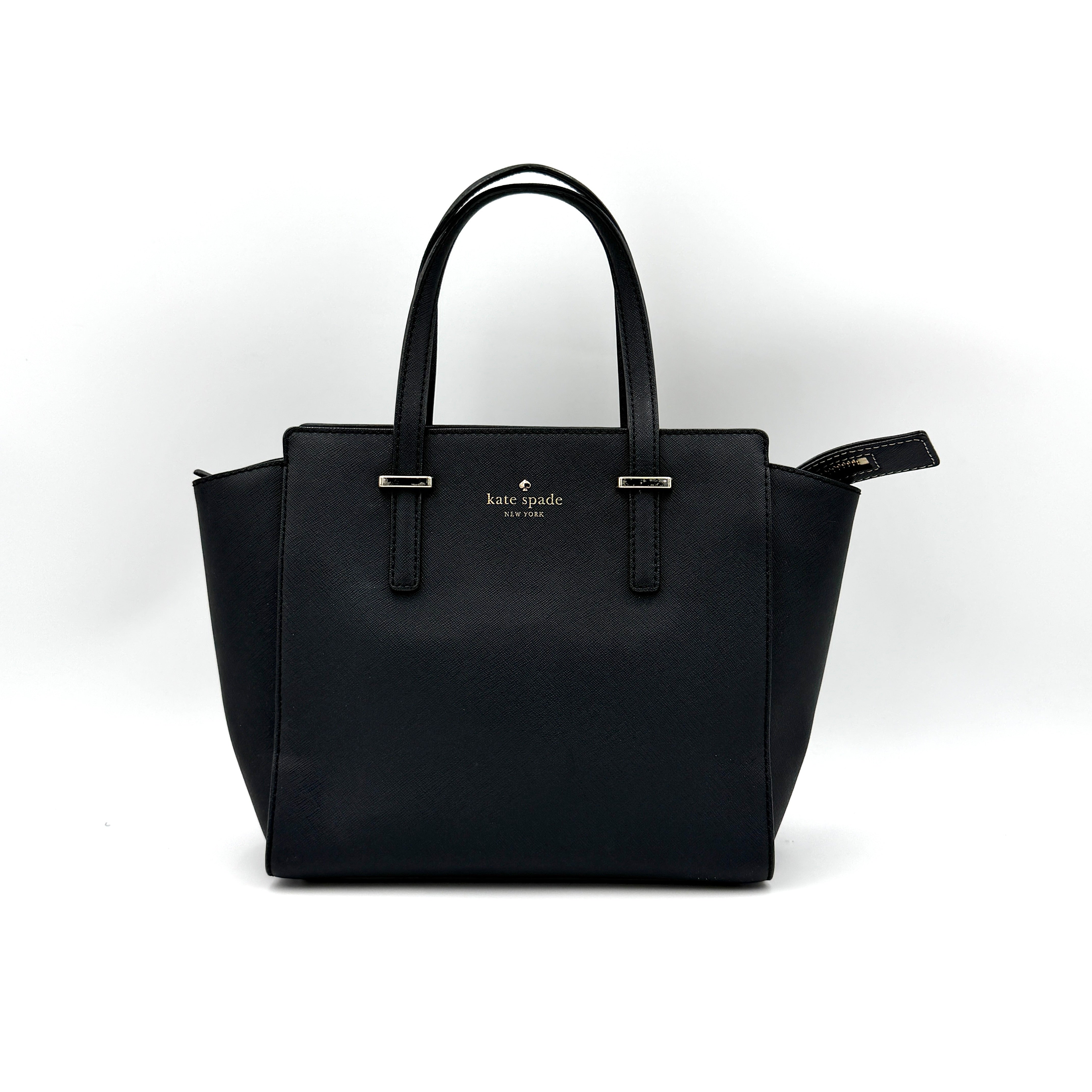 Kate Spade black Hayden handbag with structured handles and a detachable strap displayed beside it.
