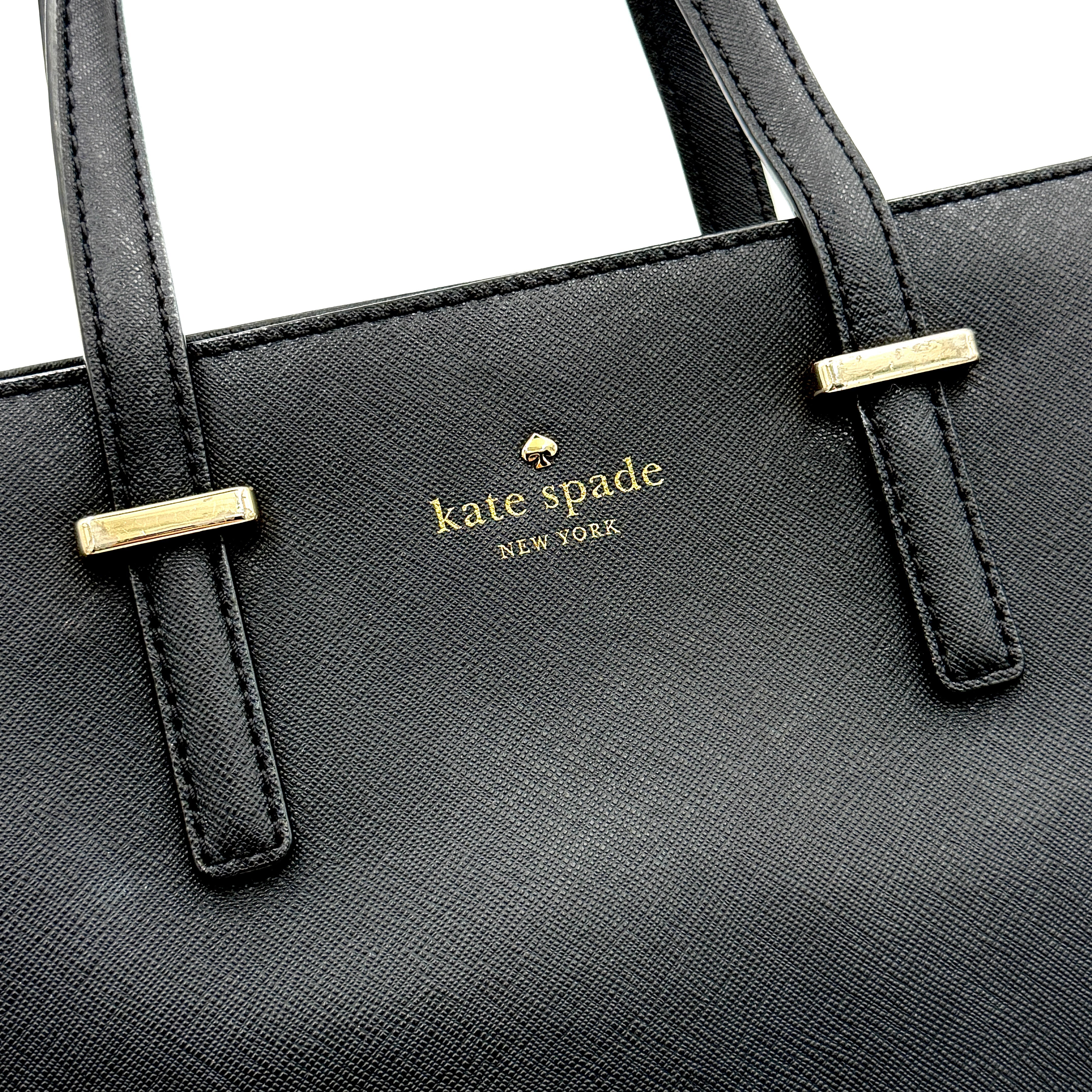 Kate Spade black Hayden handbag with structured handles and a detachable strap displayed beside it.