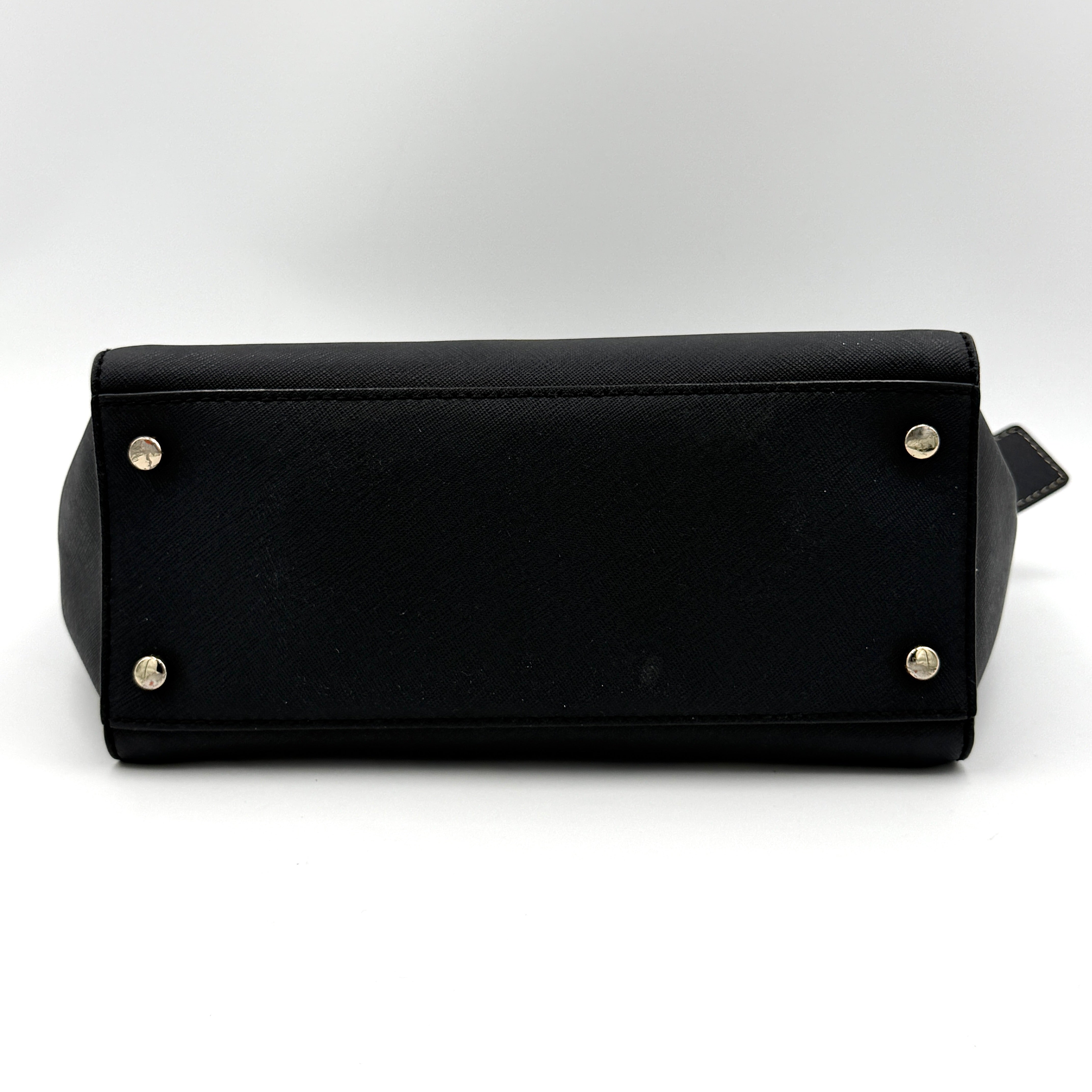 Kate Spade black Hayden handbag with structured handles and a detachable strap displayed beside it.