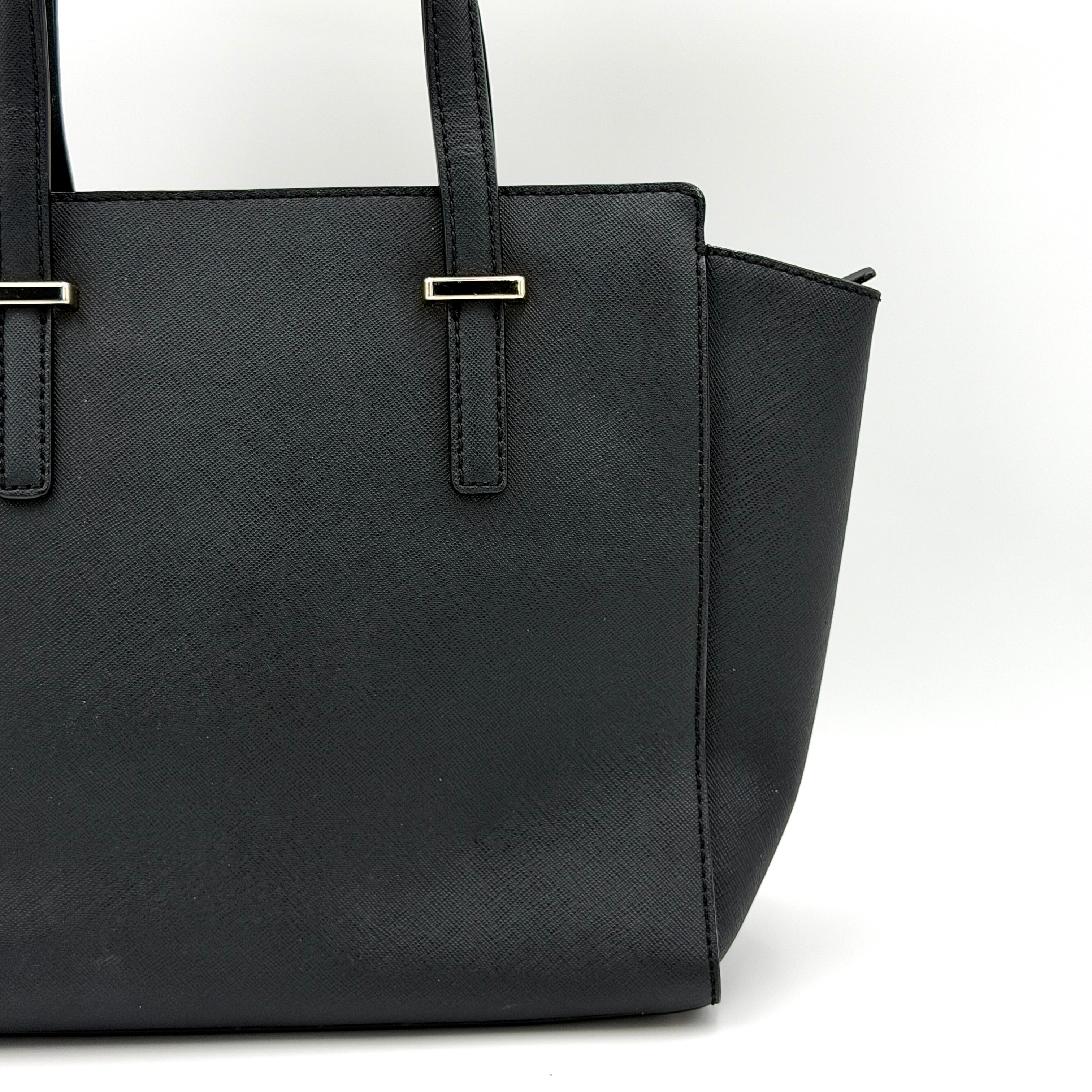 Kate Spade black Hayden handbag with structured handles and a detachable strap displayed beside it.