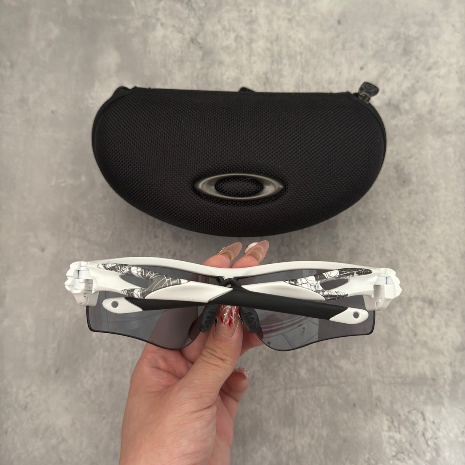 Oakley Prizm Radarlock Path sunglasses with white frame and Prizm lenses, showcasing advanced color and contrast enhancement technology for superior clarity in sports performance.