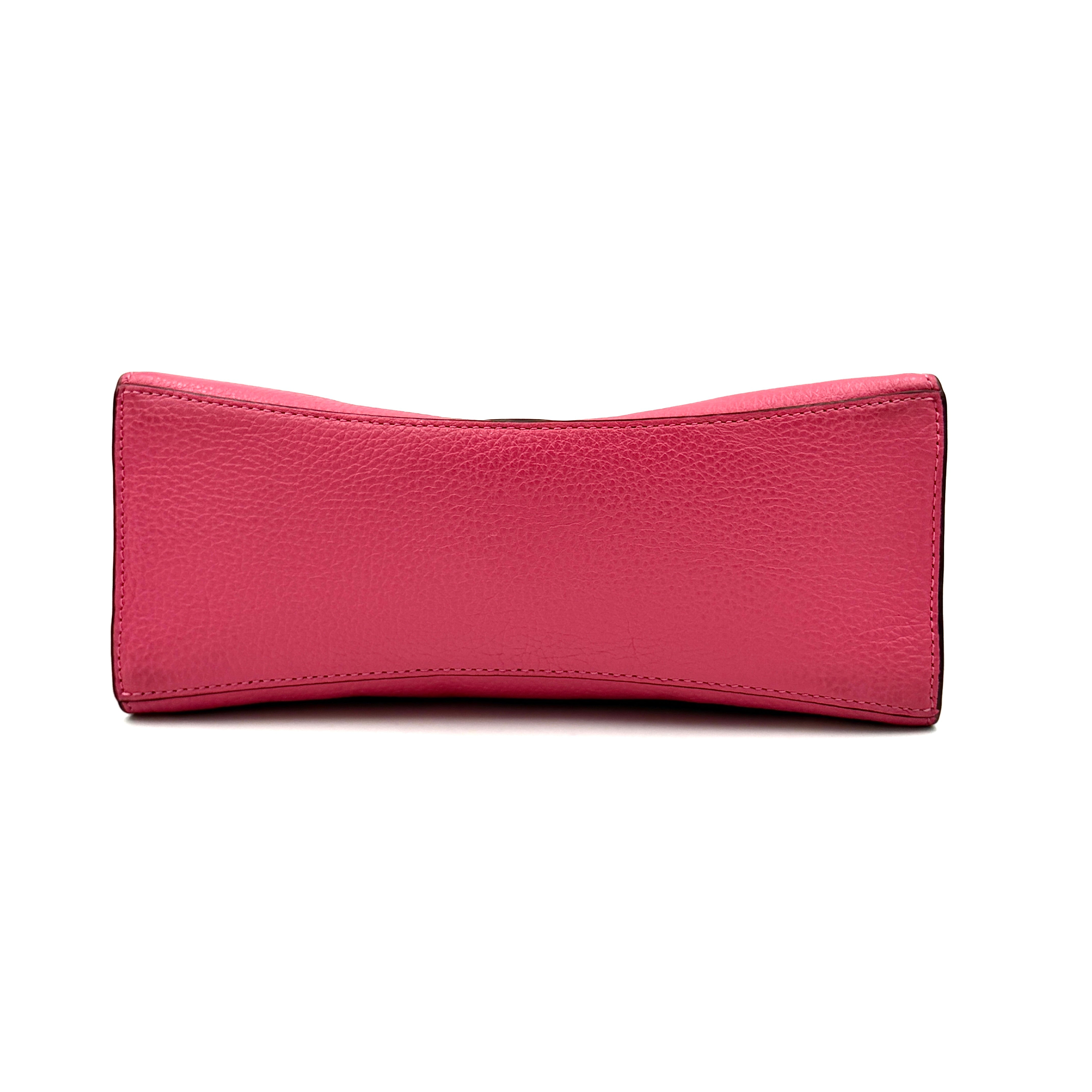 Coach Pepper Satchel in bold pink pebbled leather, featuring a structured silhouette and gold logo push-lock hardware.