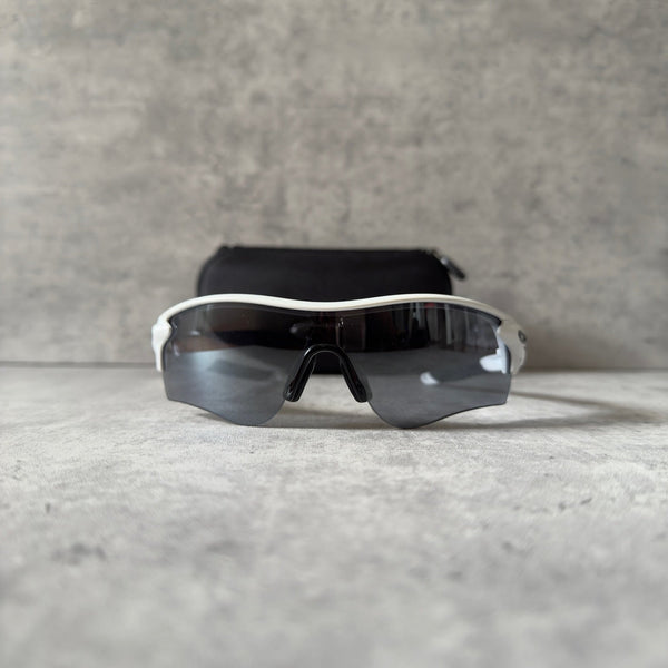 Oakley Prizm Radarlock Path sunglasses with white frame and Prizm lenses, showcasing advanced color and contrast enhancement technology for superior clarity in sports performance.