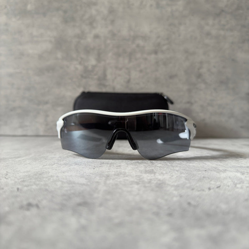 Oakley Prizm Radarlock Path sunglasses with white frame and Prizm lenses, showcasing advanced color and contrast enhancement technology for superior clarity in sports performance.