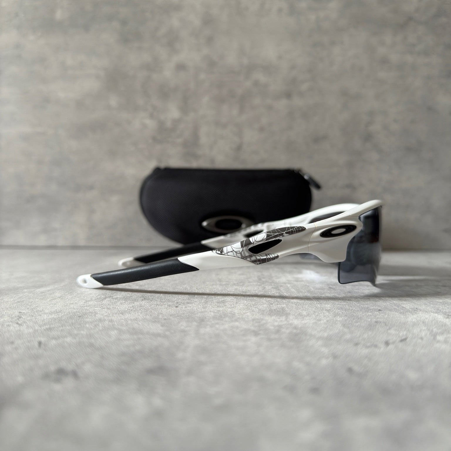 Oakley Prizm Radarlock Path sunglasses with white frame and Prizm lenses, showcasing advanced color and contrast enhancement technology for superior clarity in sports performance.