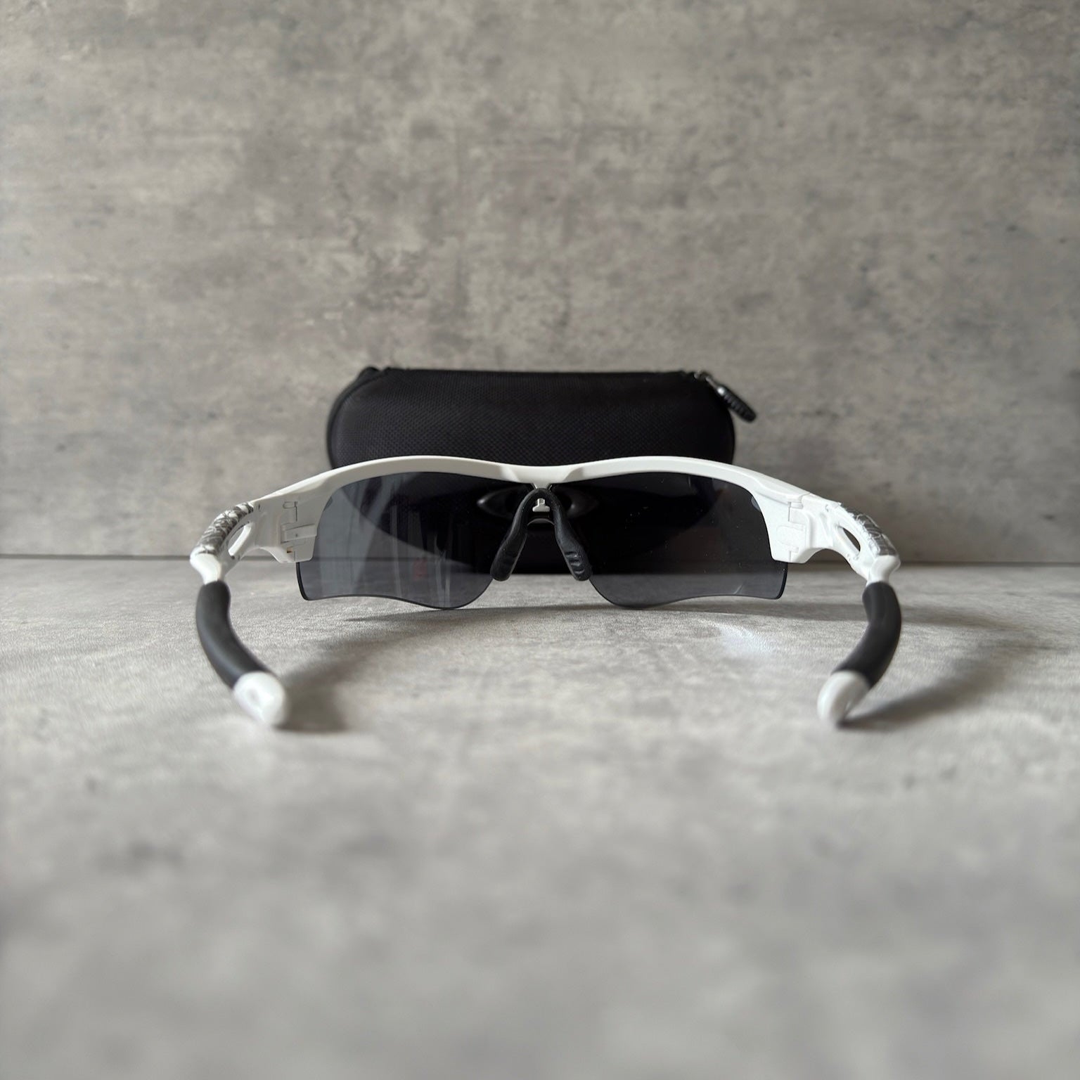 Oakley Prizm Radarlock Path sunglasses with white frame and Prizm lenses, showcasing advanced color and contrast enhancement technology for superior clarity in sports performance.