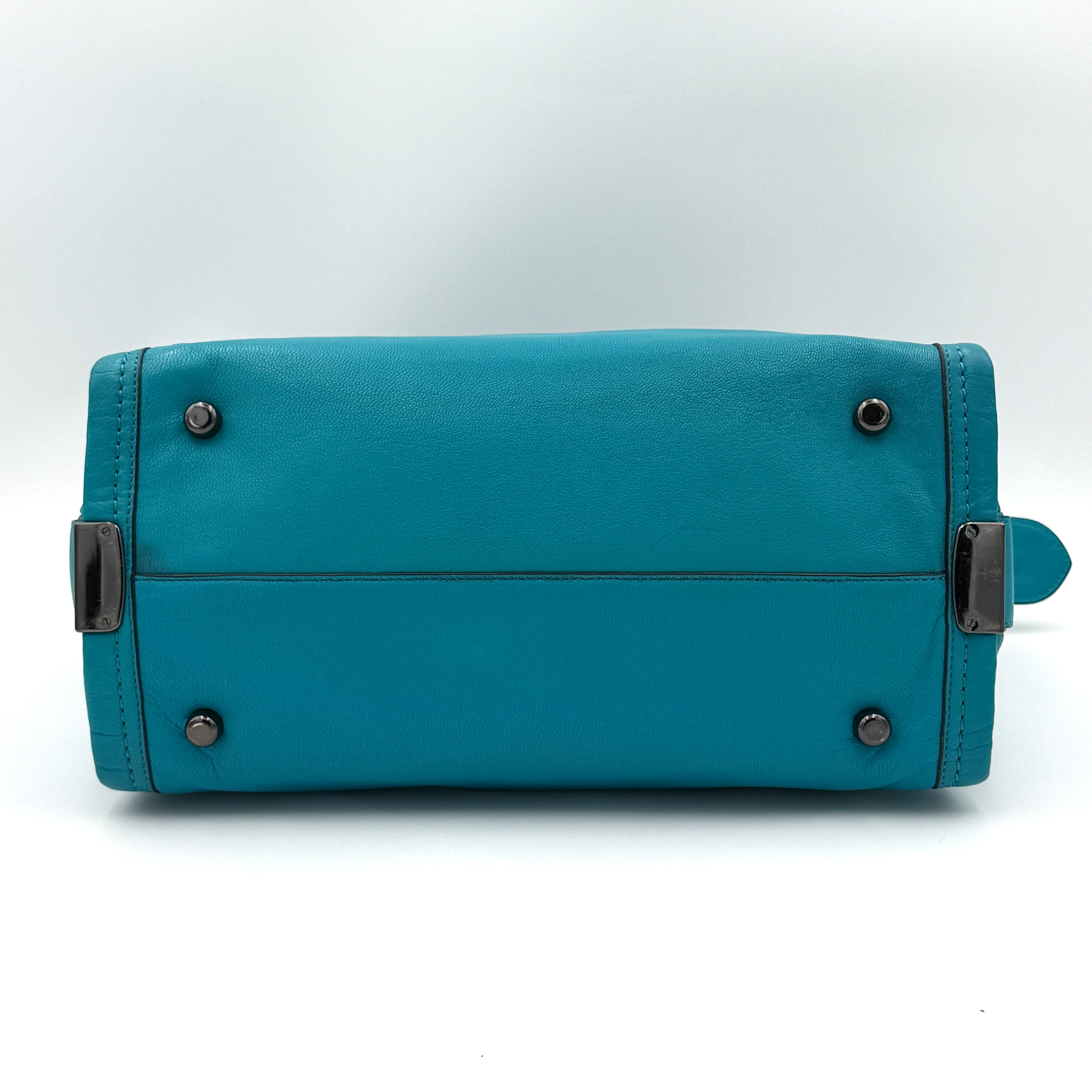 Coach Swagger 27 Carryall in vivid turquoise leather with double top handles, gunmetal hardware, and detachable strap.