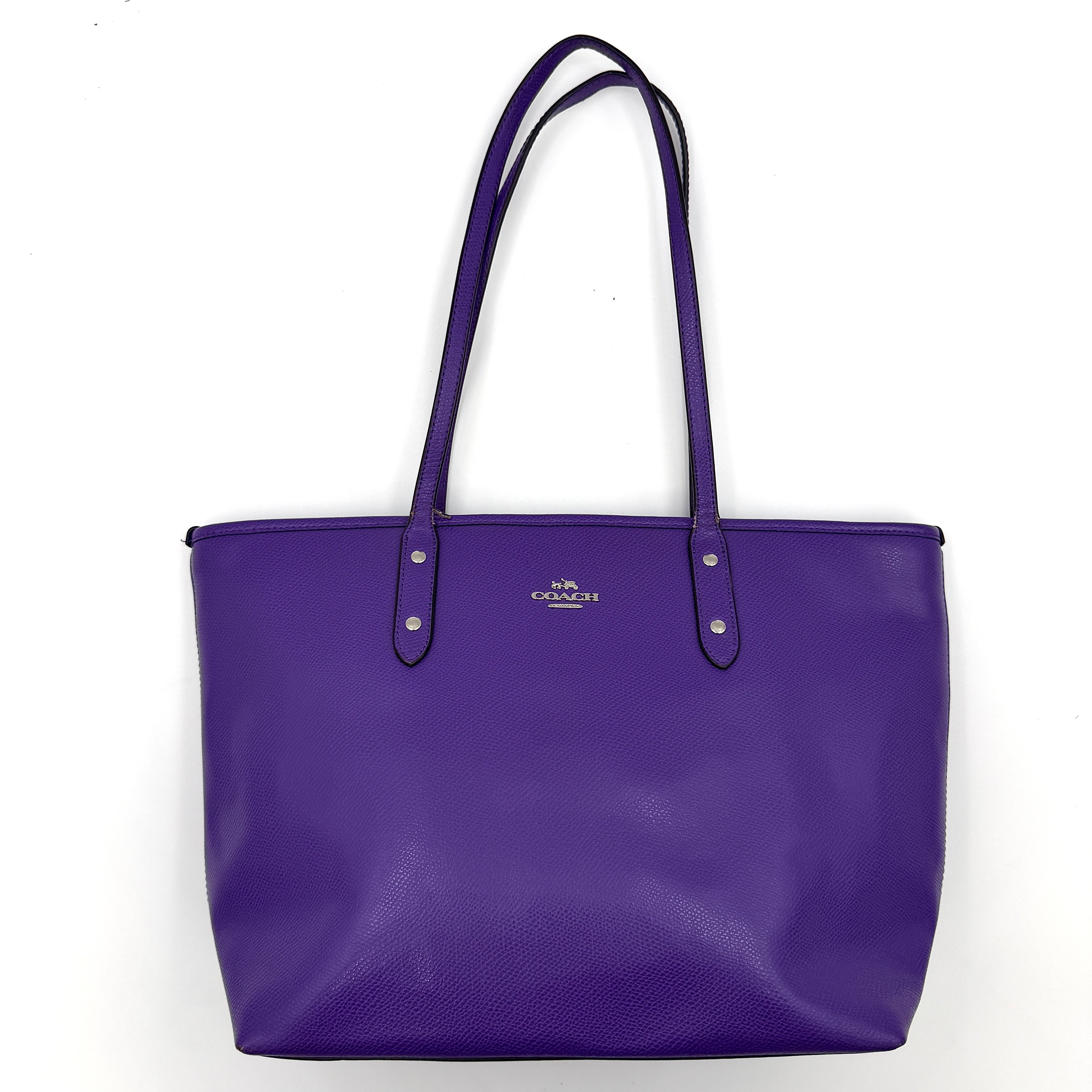 Coach City Zip Tote Bag in vibrant purple grained leather with dual shoulder straps and silver-tone hardware.