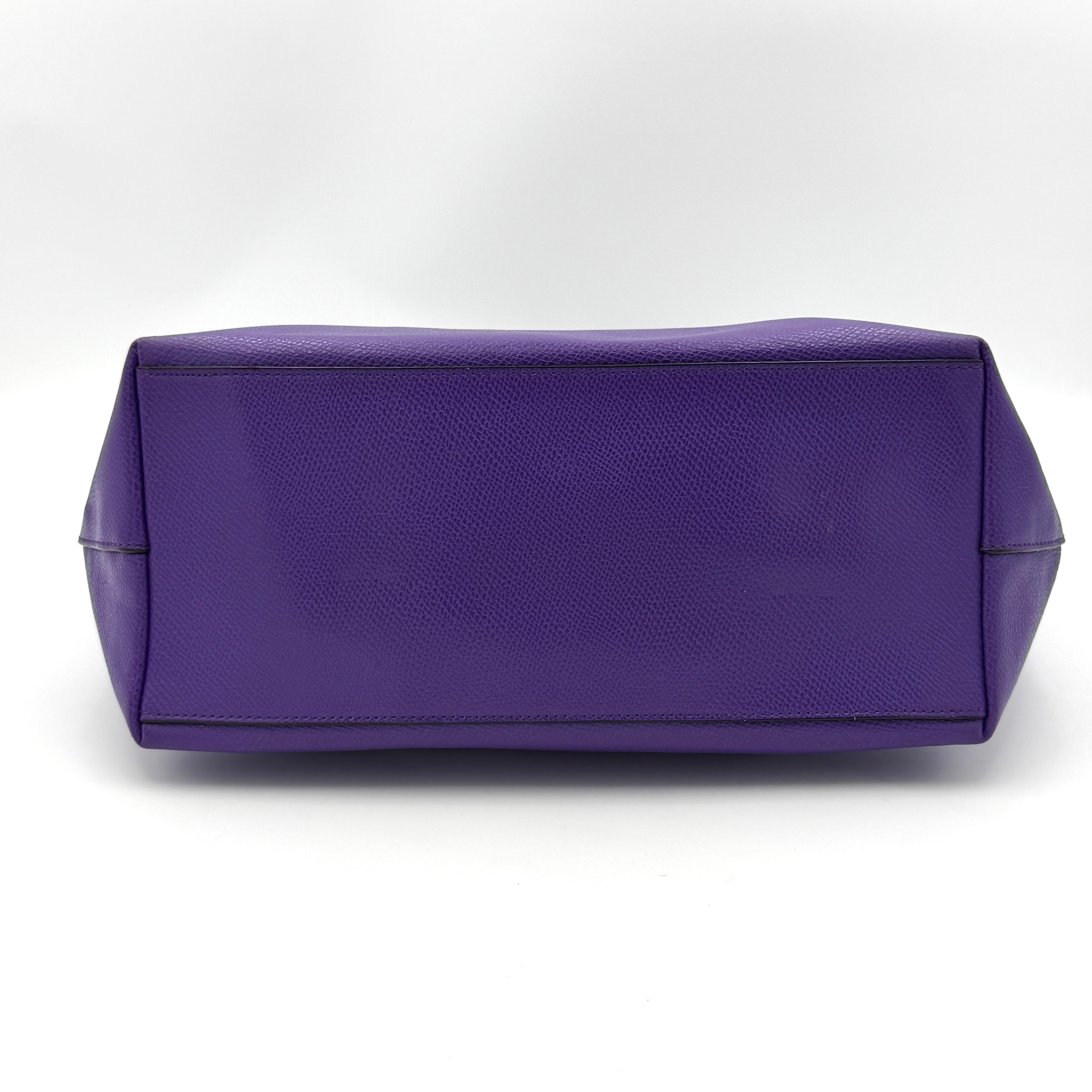 Coach City Zip Tote Bag in vibrant purple grained leather with dual shoulder straps and silver-tone hardware.