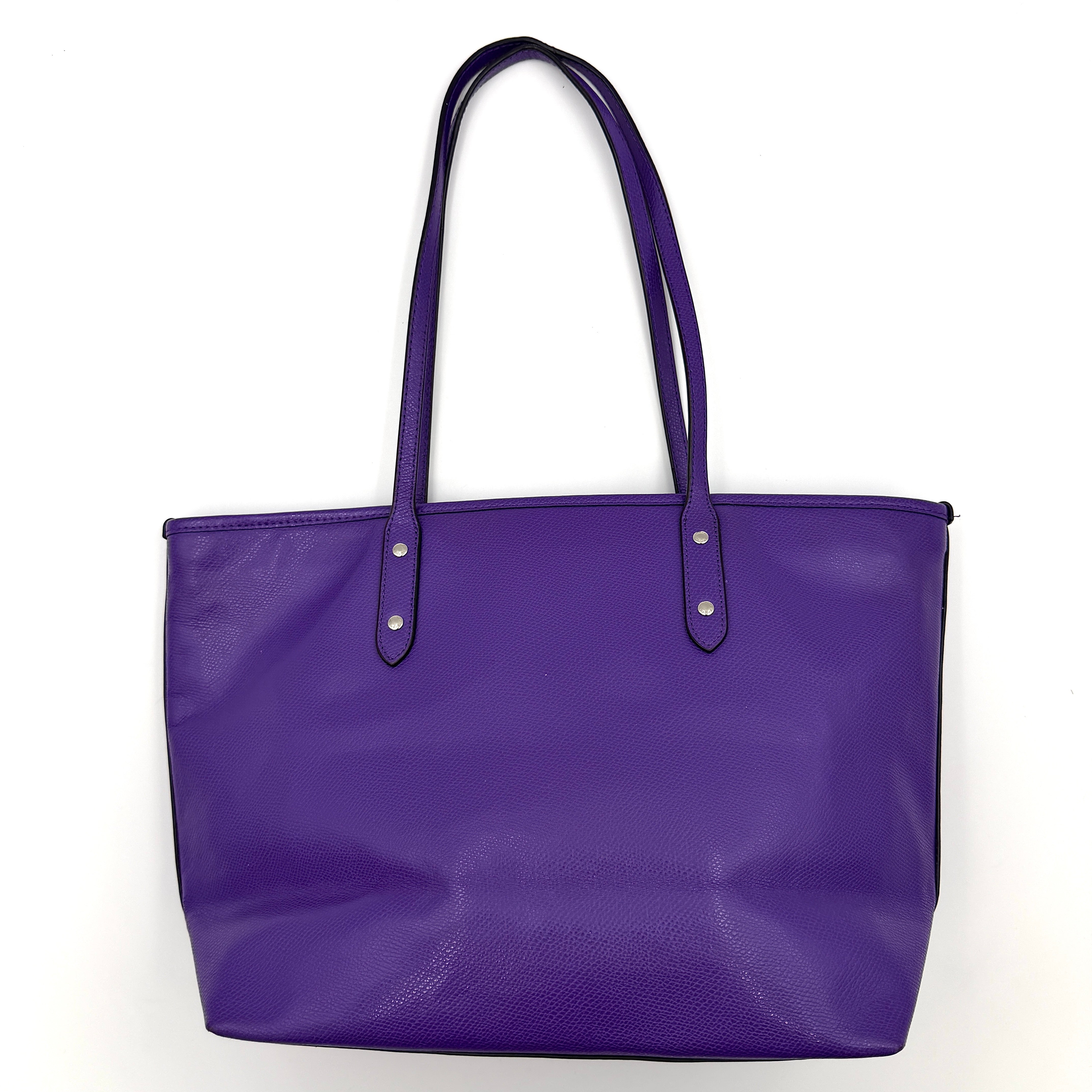 Coach City Zip Tote Bag in vibrant purple grained leather with dual shoulder straps and silver-tone hardware.