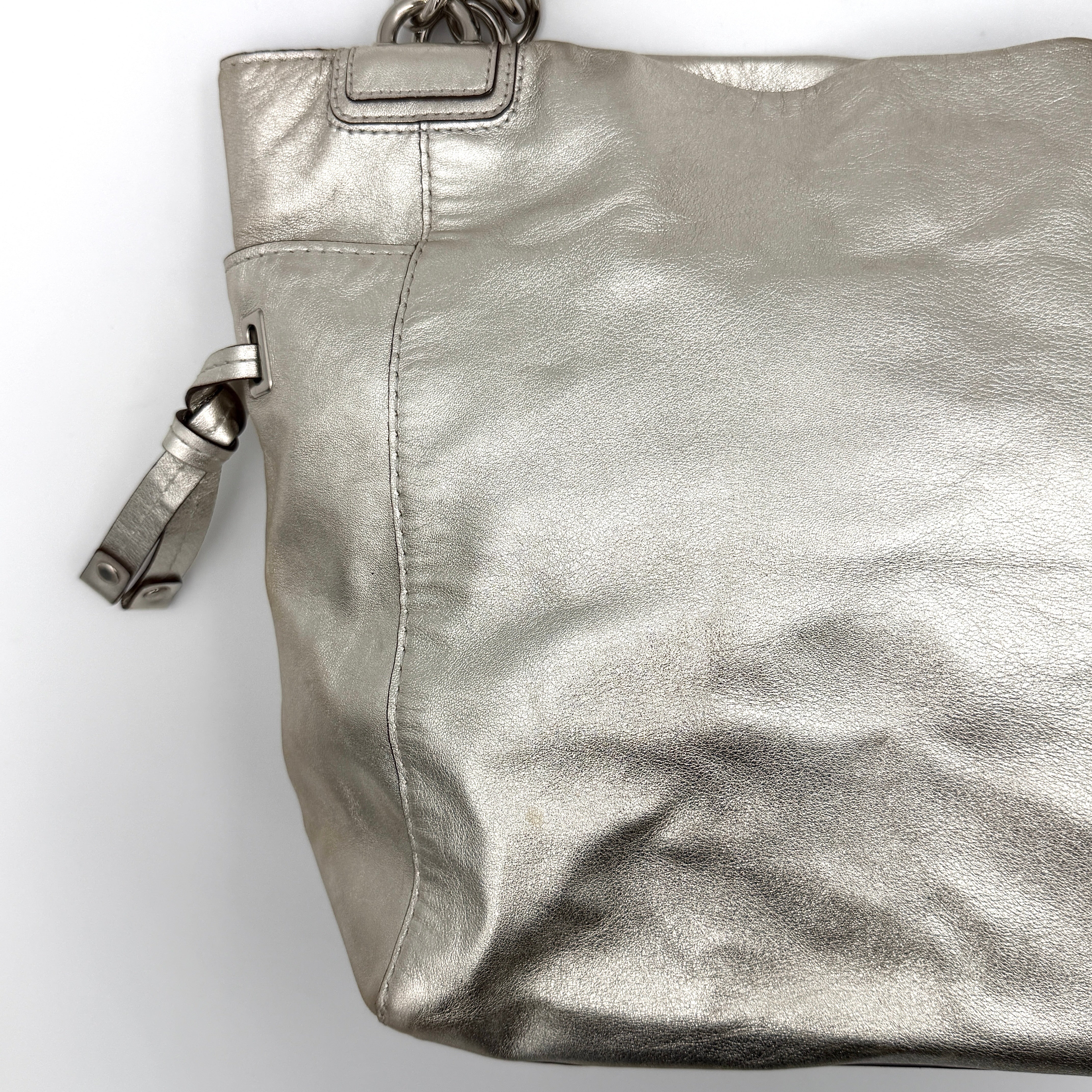 Coach Peyton Metallic Shoulder Bag in shimmering silver leather with dual top handles and polished hardware.