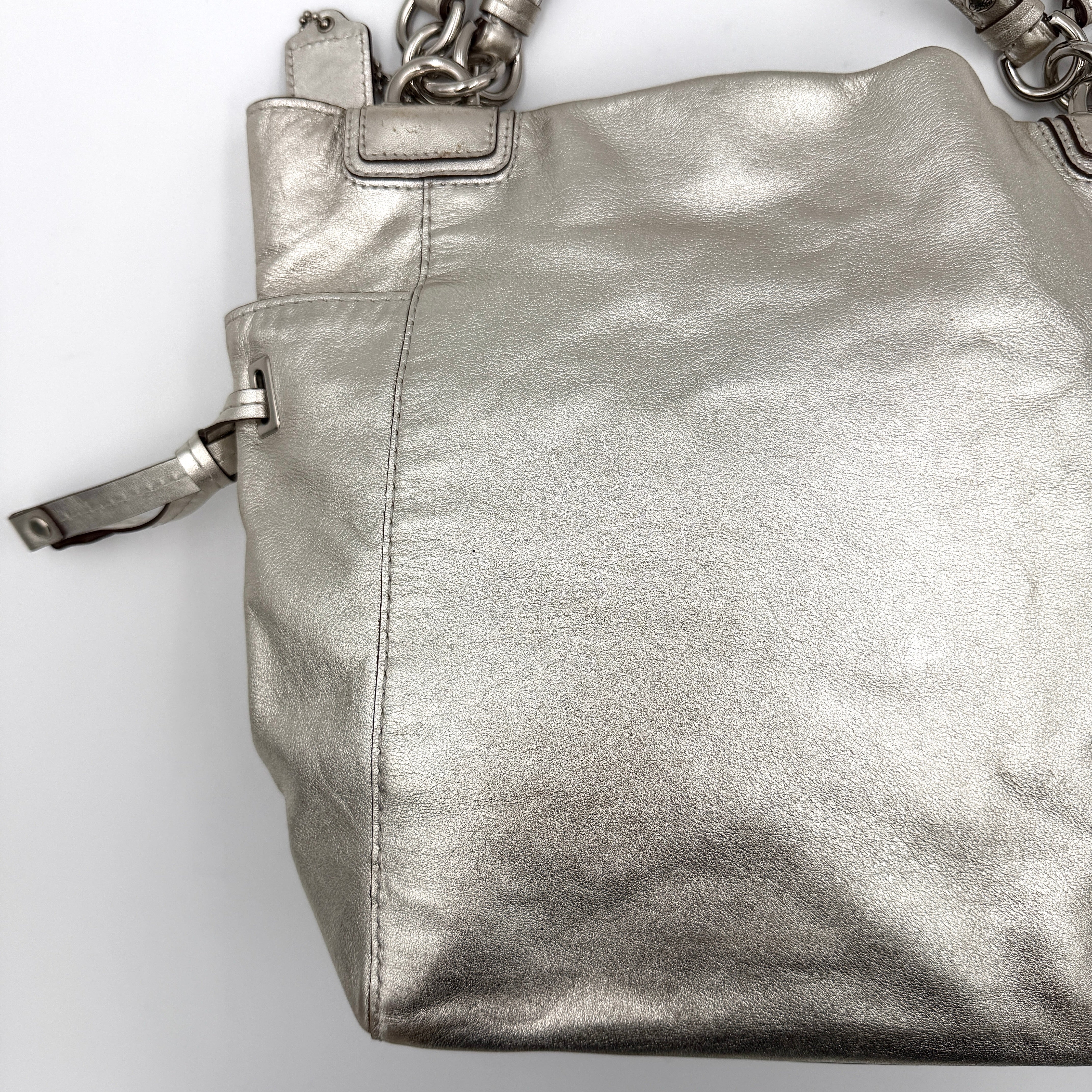 Coach Peyton Metallic Shoulder Bag in shimmering silver leather with dual top handles and polished hardware.