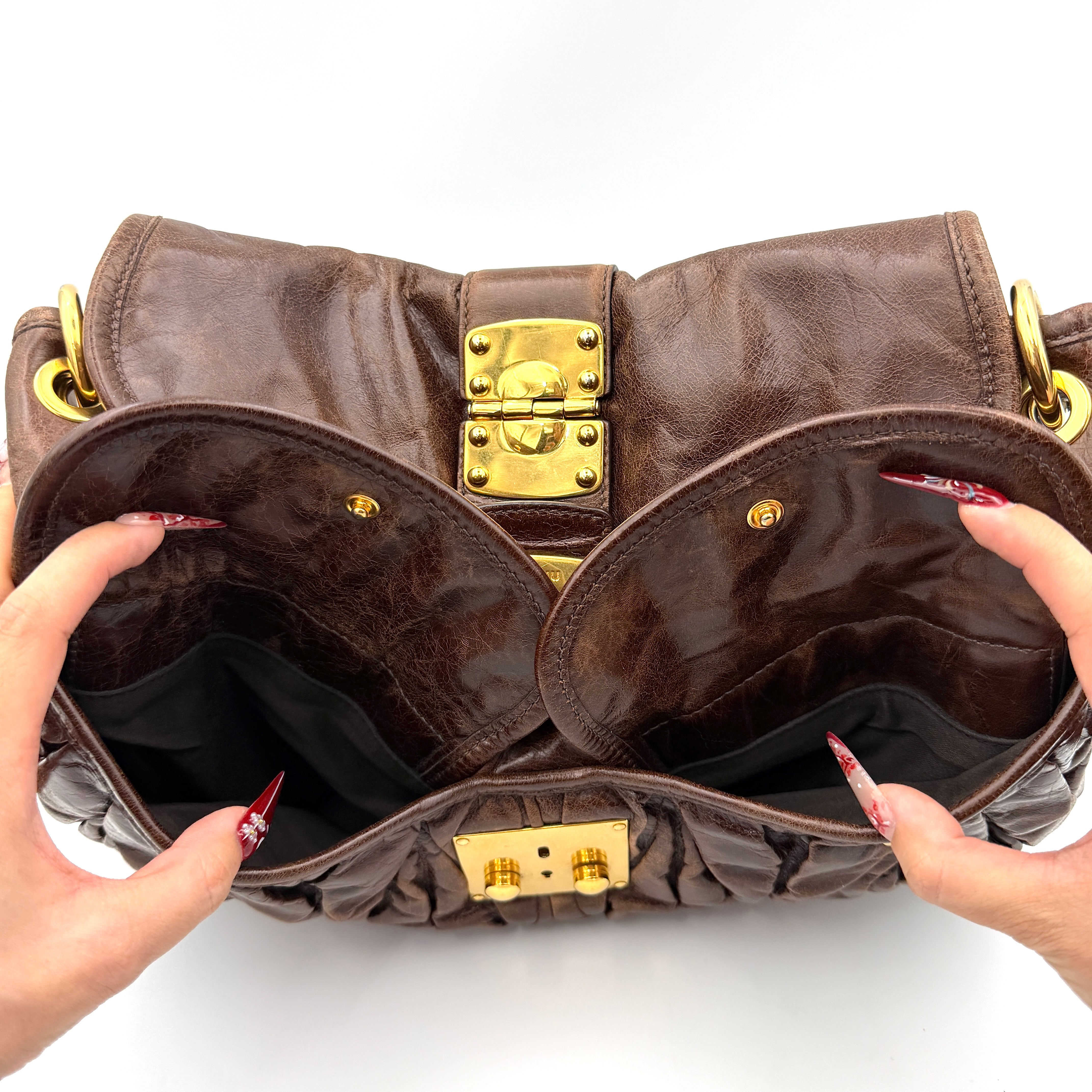 Miu Miu Coffer Hobo bag in deep brown matelassé leather with braided handle, gold hardware, and detachable strap.