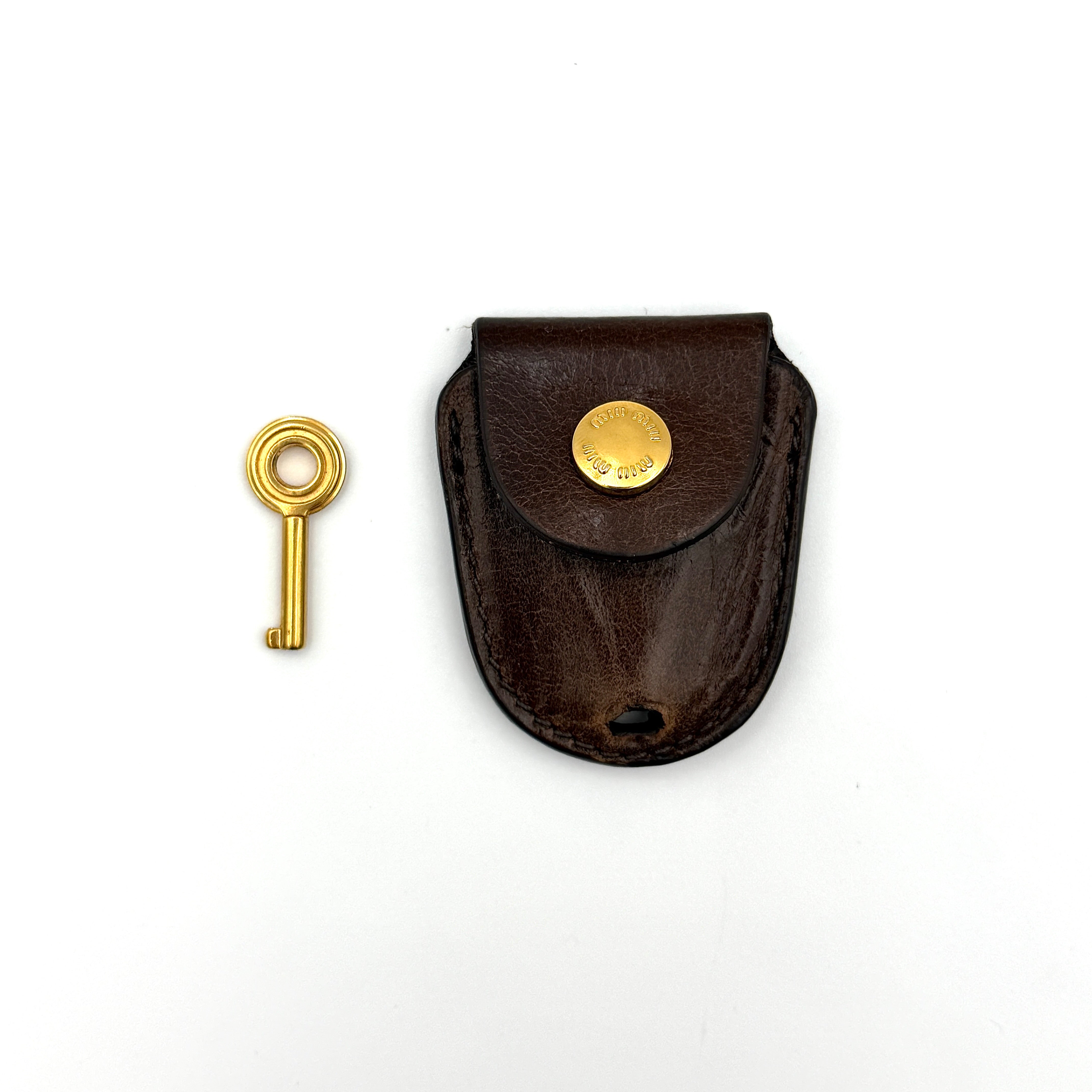 Miu Miu Coffer Hobo bag in deep brown matelassé leather with braided handle, gold hardware, and detachable strap.