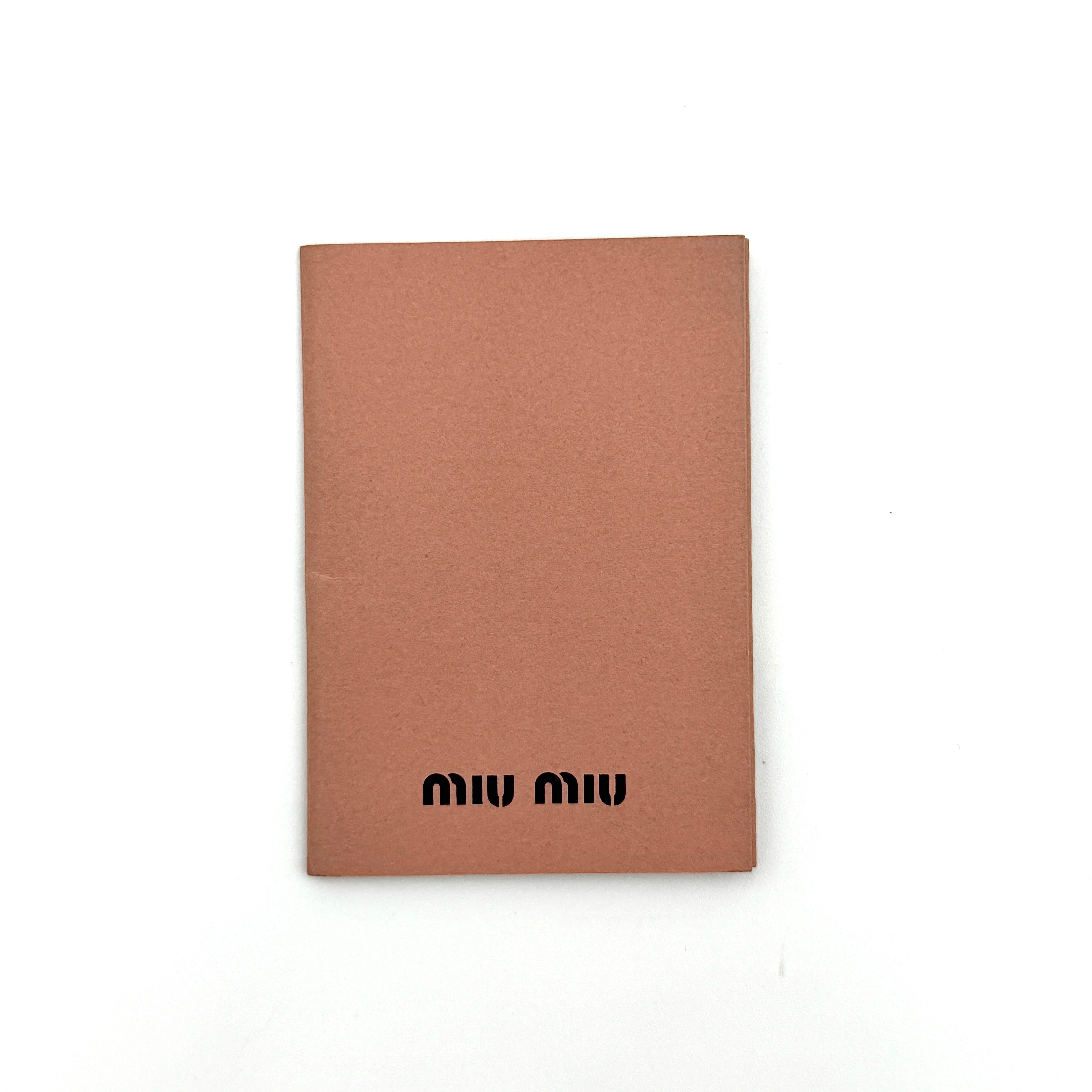 Miu Miu Coffer Hobo bag in deep brown matelassé leather with braided handle, gold hardware, and detachable strap.