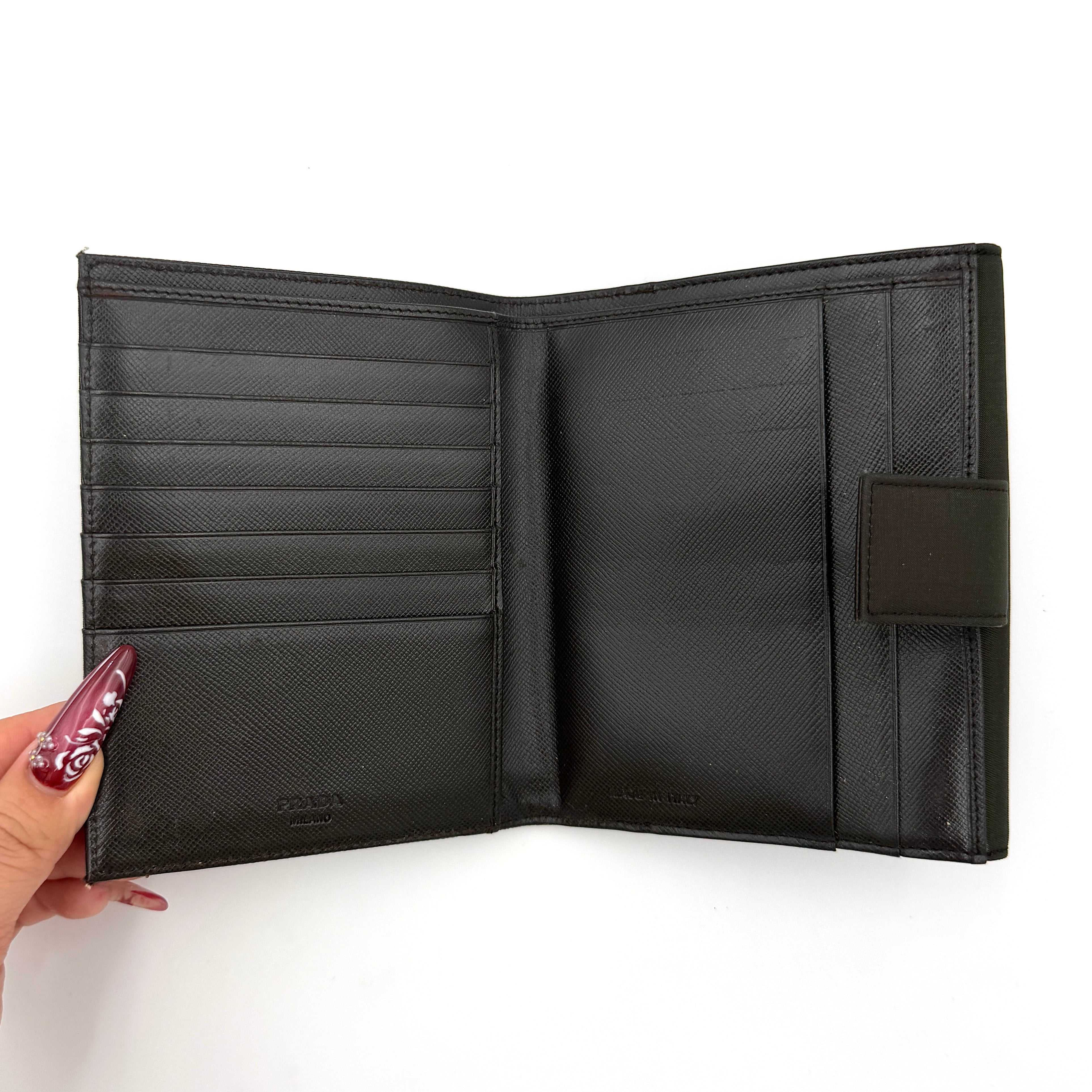Prada Tessuto Nylon Bifold Wallet in black featuring the iconic enamel triangle logo on the front flap.