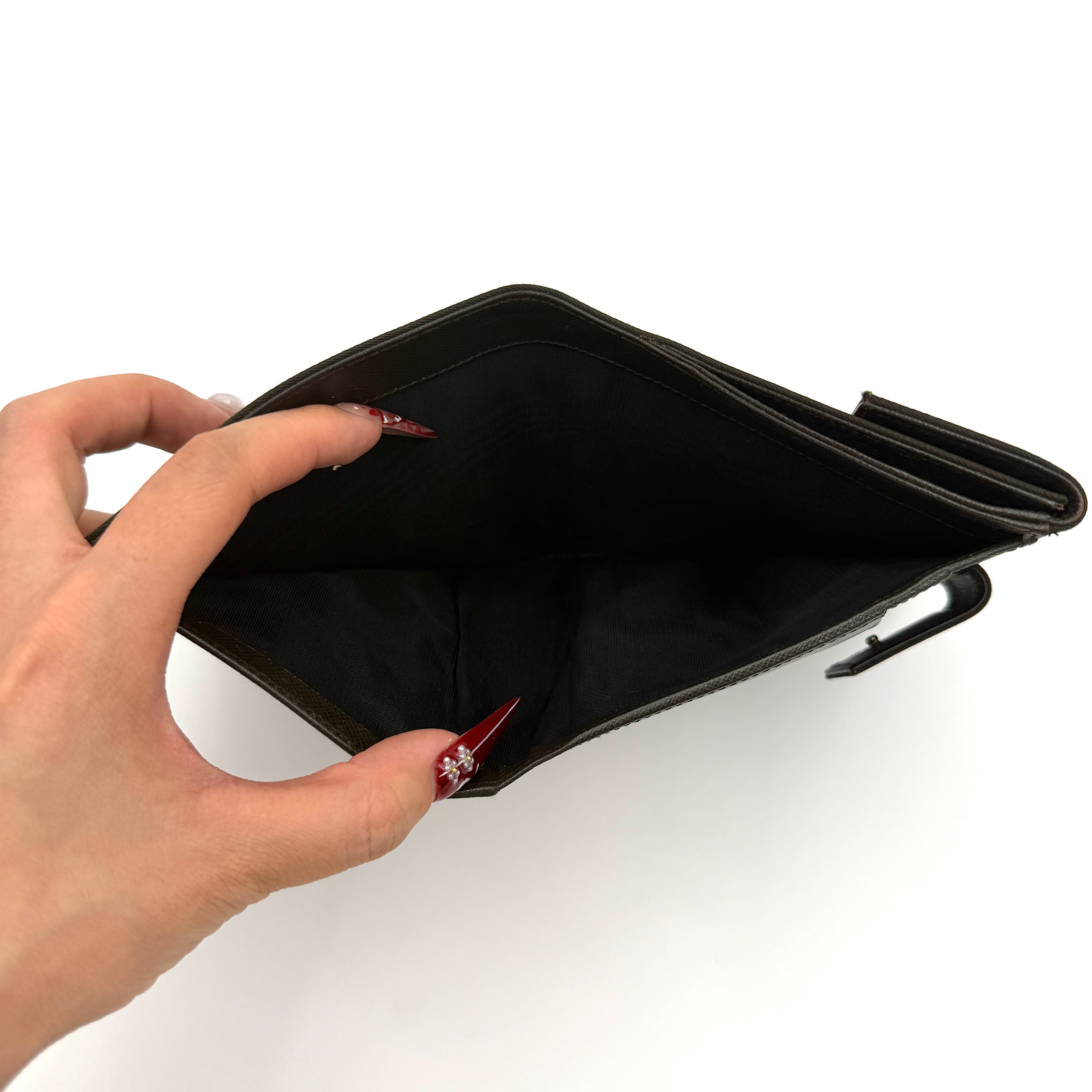 Prada Tessuto Nylon Bifold Wallet in black featuring the iconic enamel triangle logo on the front flap.