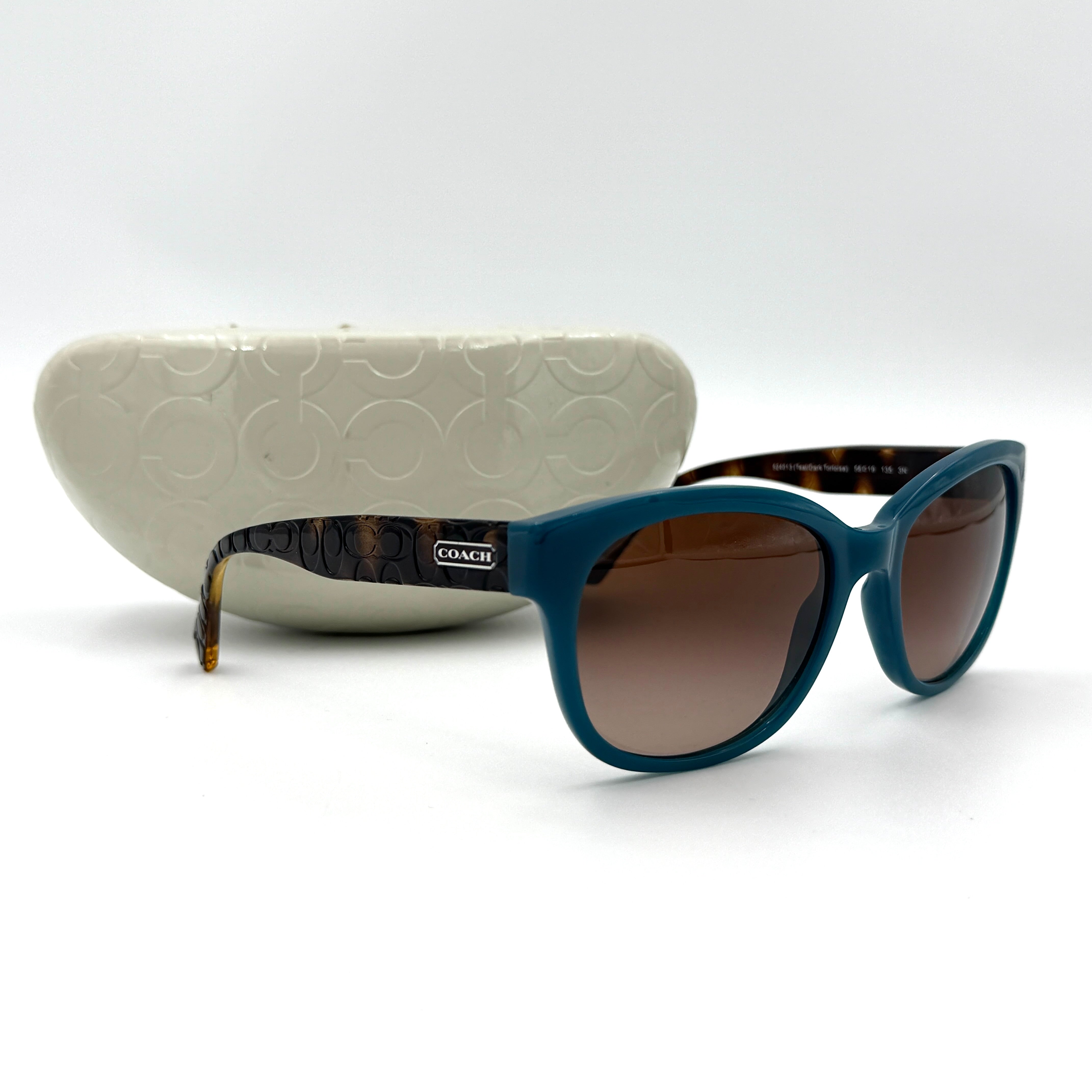 Coach HC8110 sunglasses in teal and dark tortoiseshell acetate with gradient brown lenses, shown at a three-quarter angle.