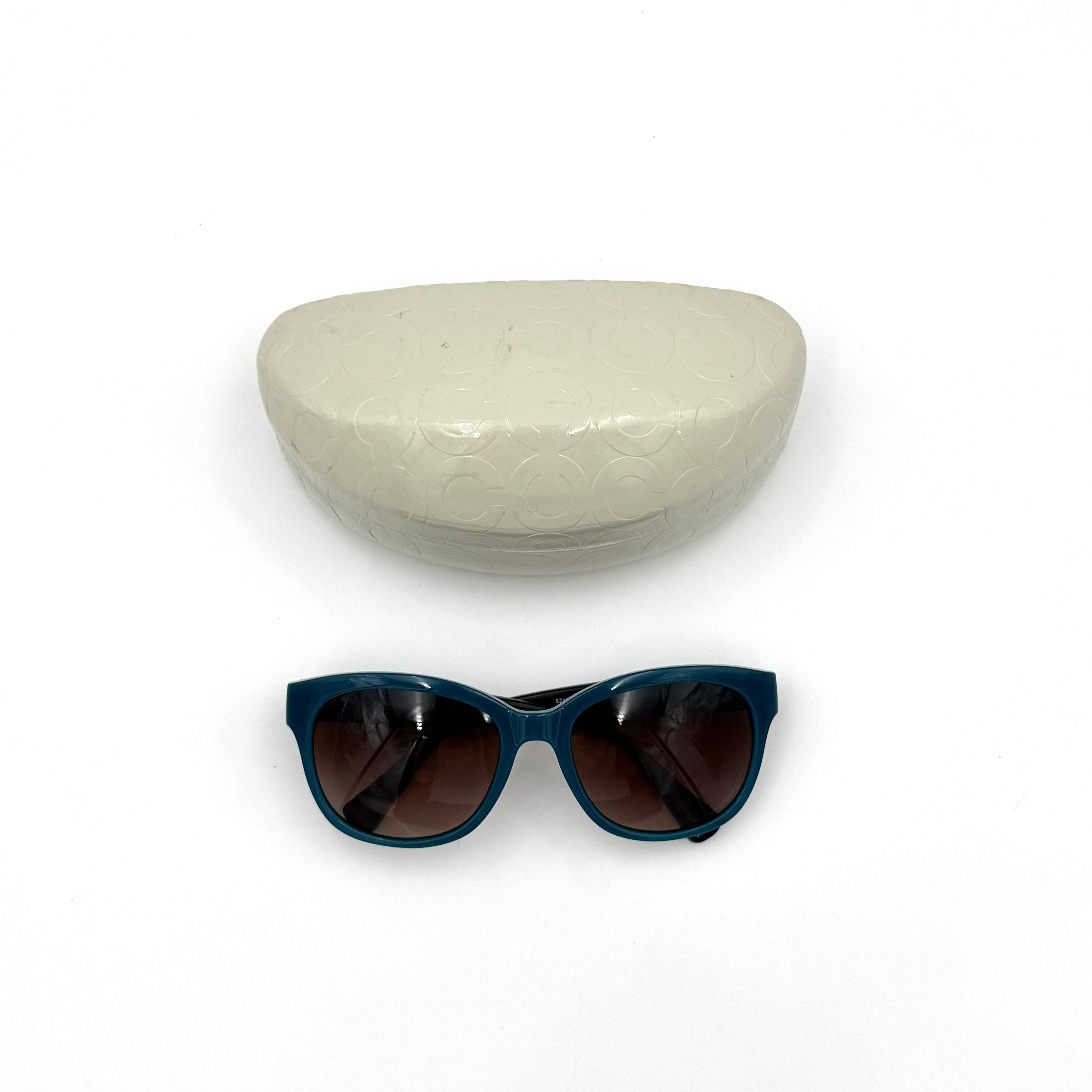 Coach HC8110 sunglasses in teal and dark tortoiseshell acetate with gradient brown lenses, shown at a three-quarter angle.