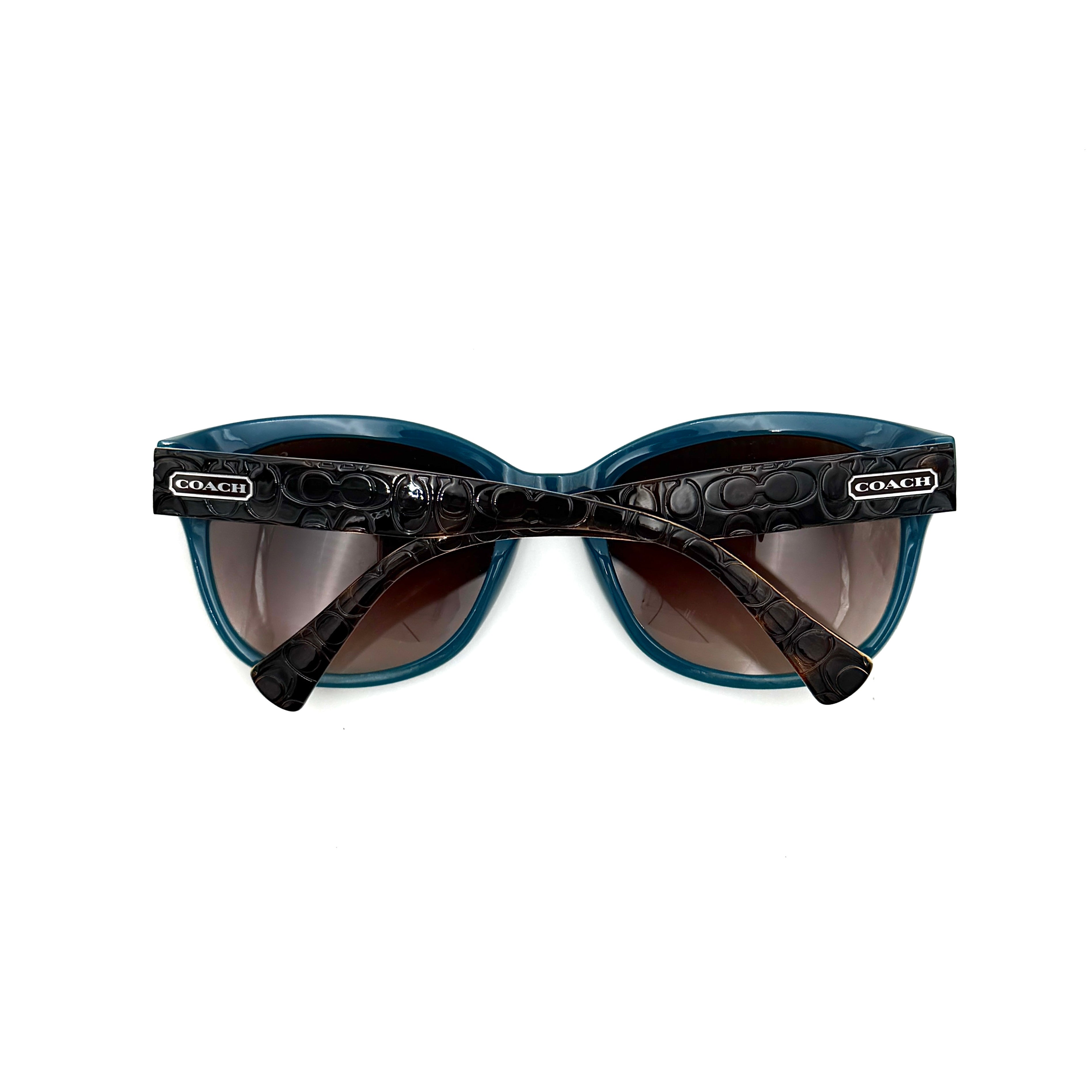 Coach HC8110 sunglasses in teal and dark tortoiseshell acetate with gradient brown lenses, shown at a three-quarter angle.
