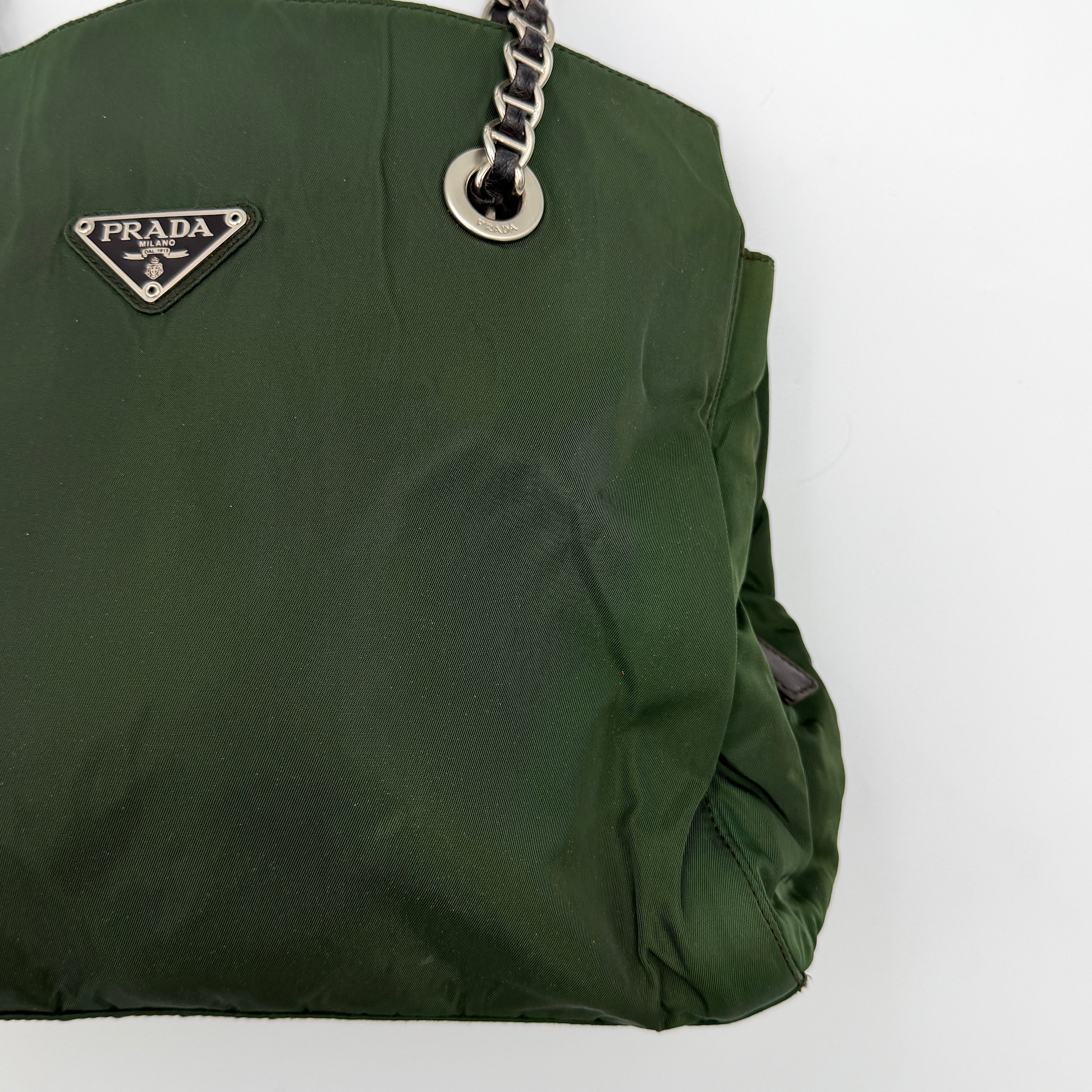 A Prada Tessuto Nylon Chain Shoulder Bag in deep green with silver-tone chain straps, featuring the iconic triangular logo on the front.