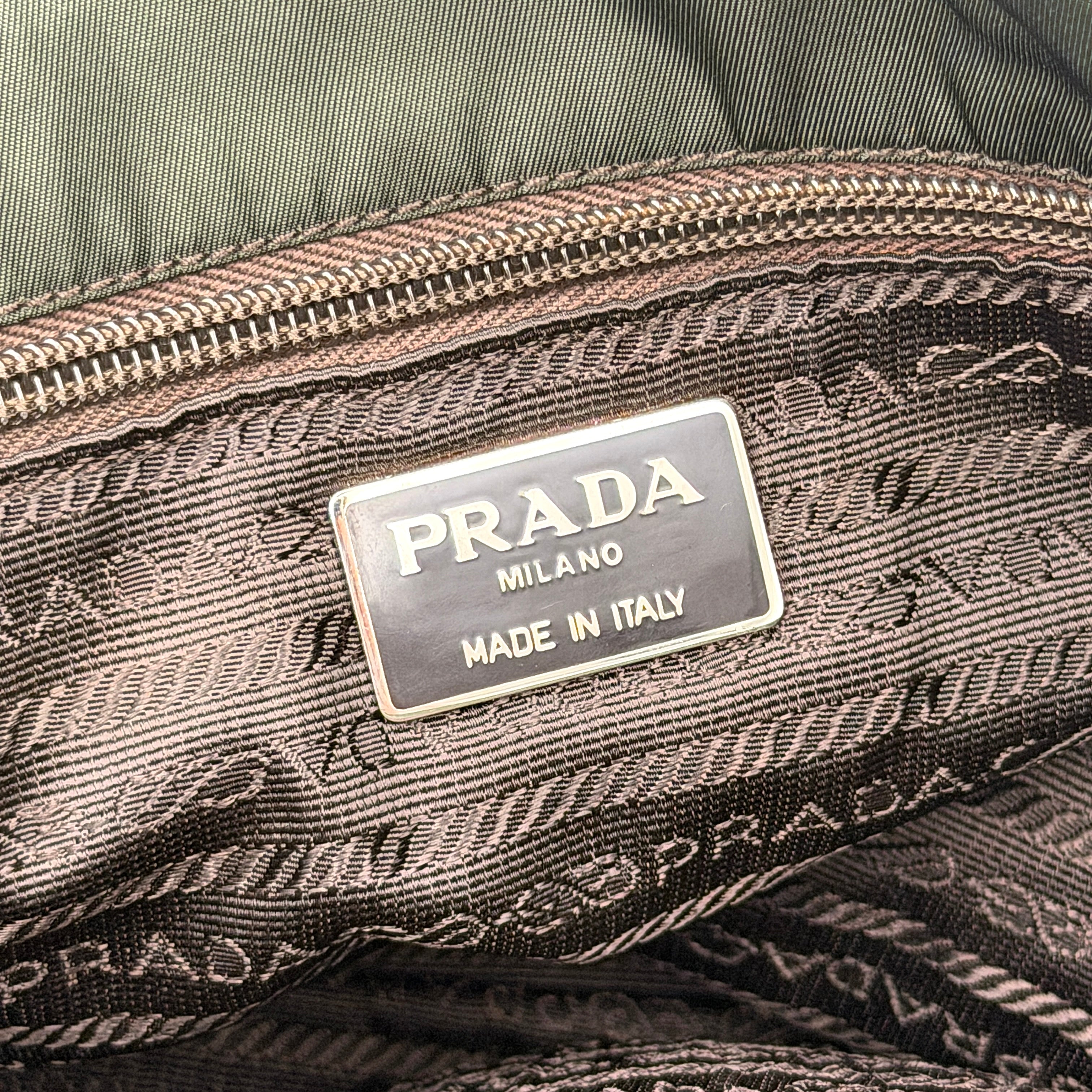 A Prada Tessuto Nylon Chain Shoulder Bag in deep green with silver-tone chain straps, featuring the iconic triangular logo on the front.