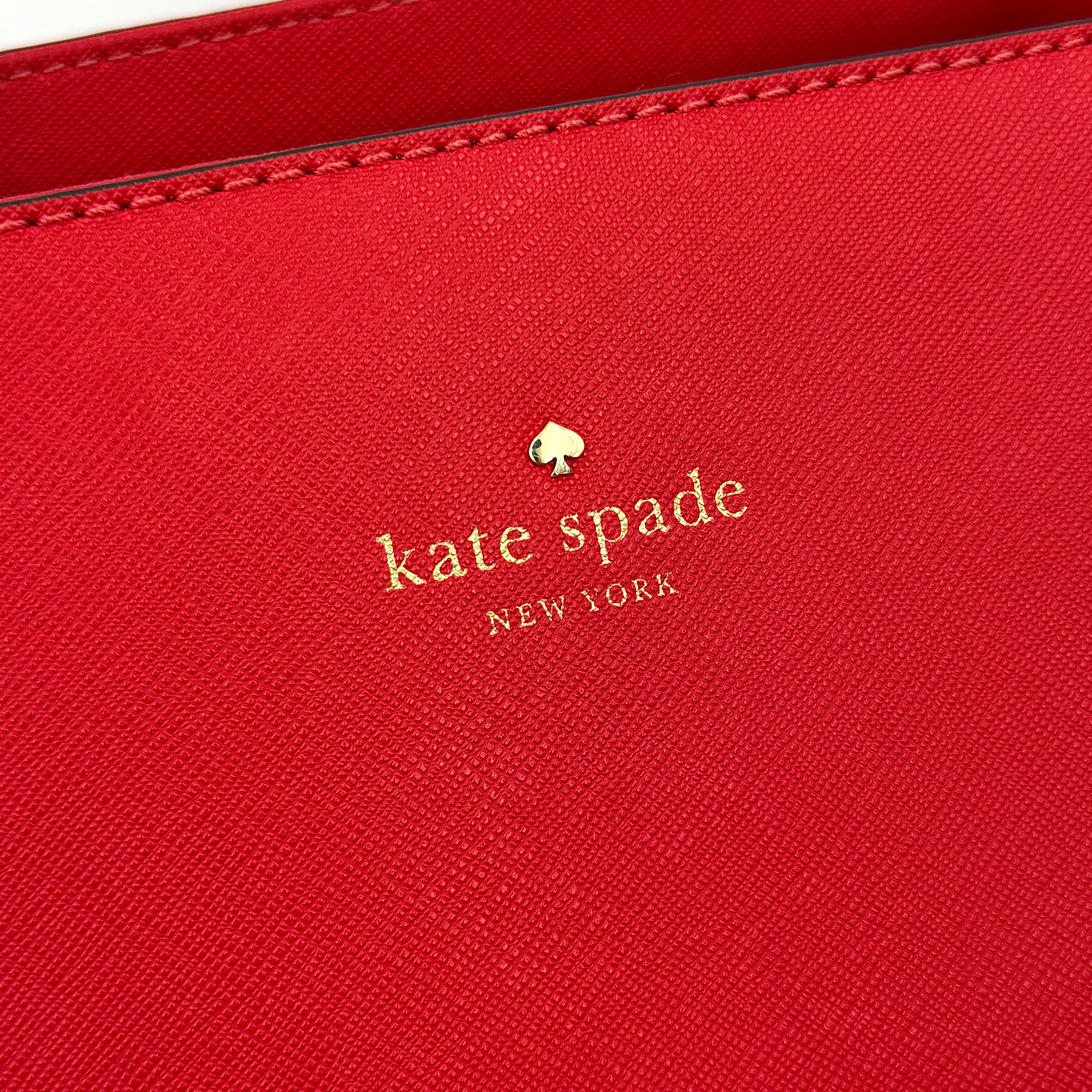 A vivid red Kate Spade Cedar Street Harmony Tote Bag with structured handles and gold-tone logo, shown against a white background.