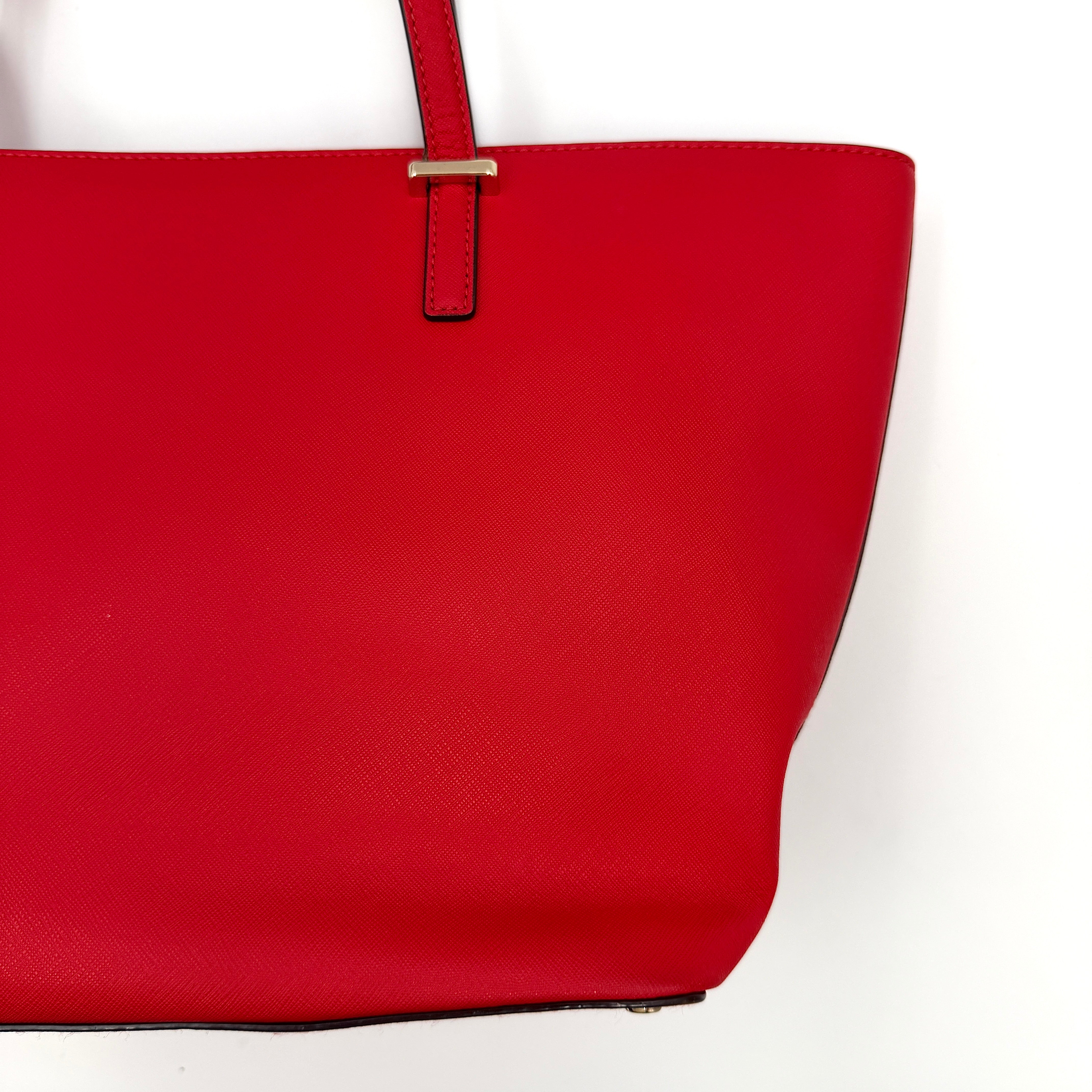 A vivid red Kate Spade Cedar Street Harmony Tote Bag with structured handles and gold-tone logo, shown against a white background.
