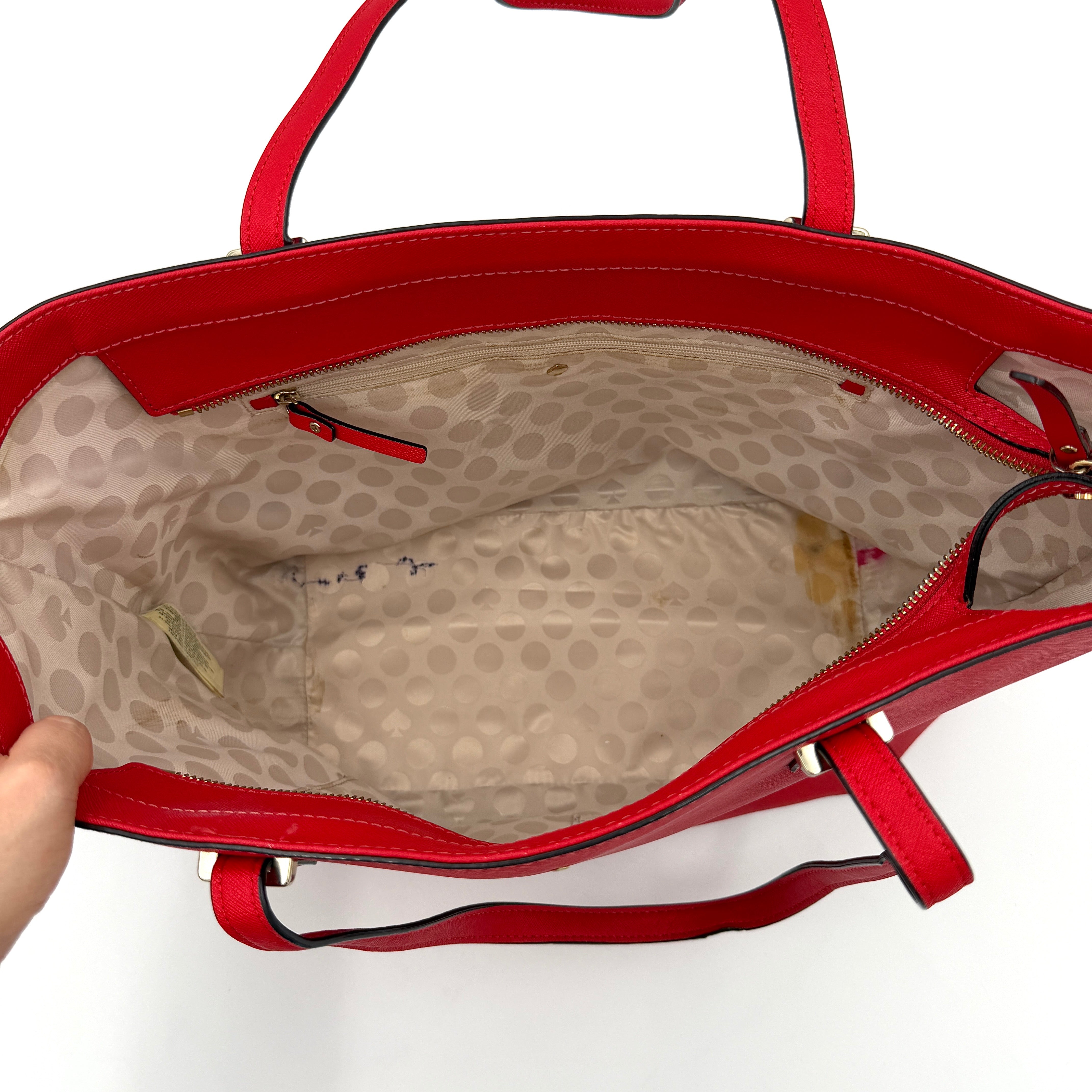 A vivid red Kate Spade Cedar Street Harmony Tote Bag with structured handles and gold-tone logo, shown against a white background.