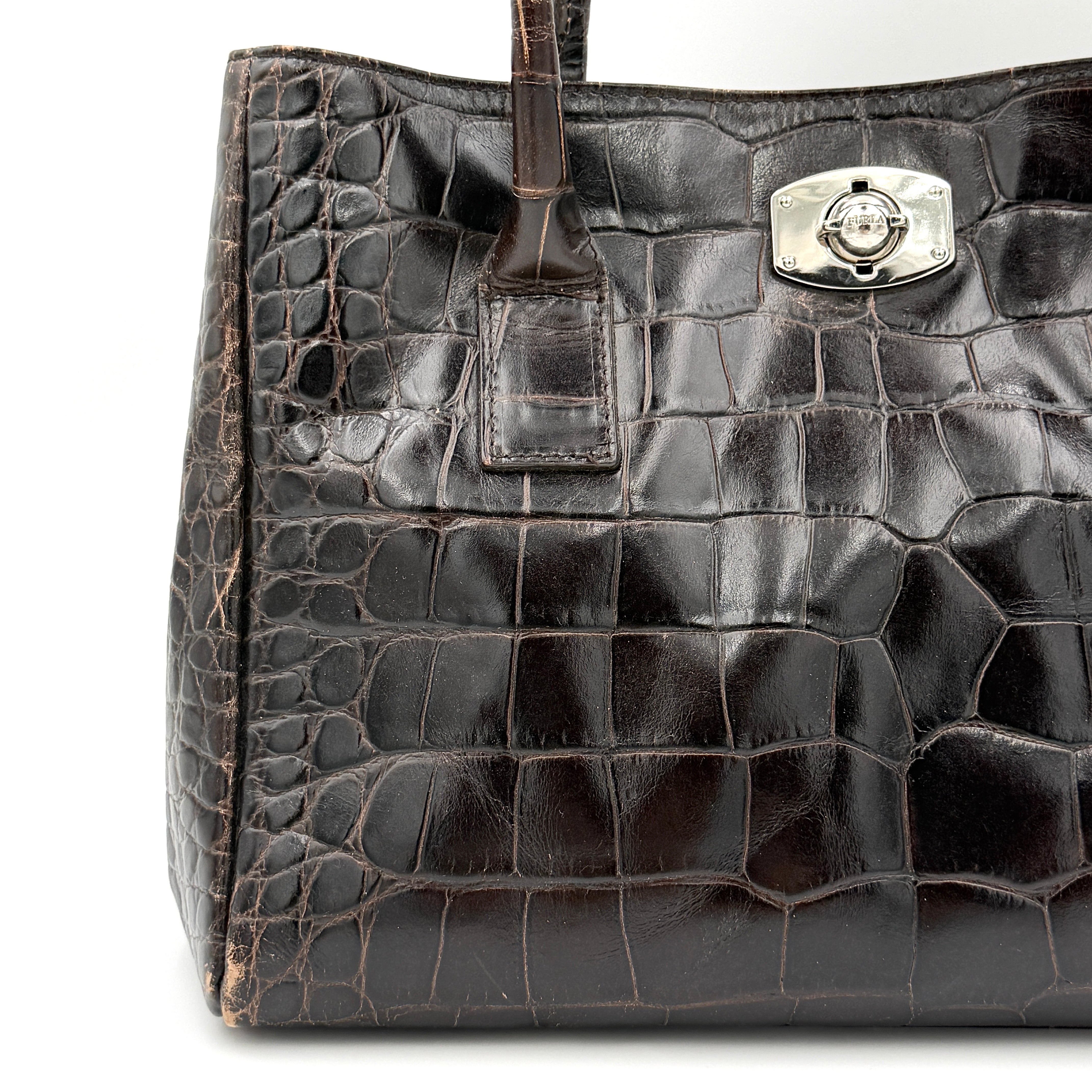 Furla croc-embossed dark brown leather handbag with structured silhouette, dual top handles, and silver turn-lock closure.