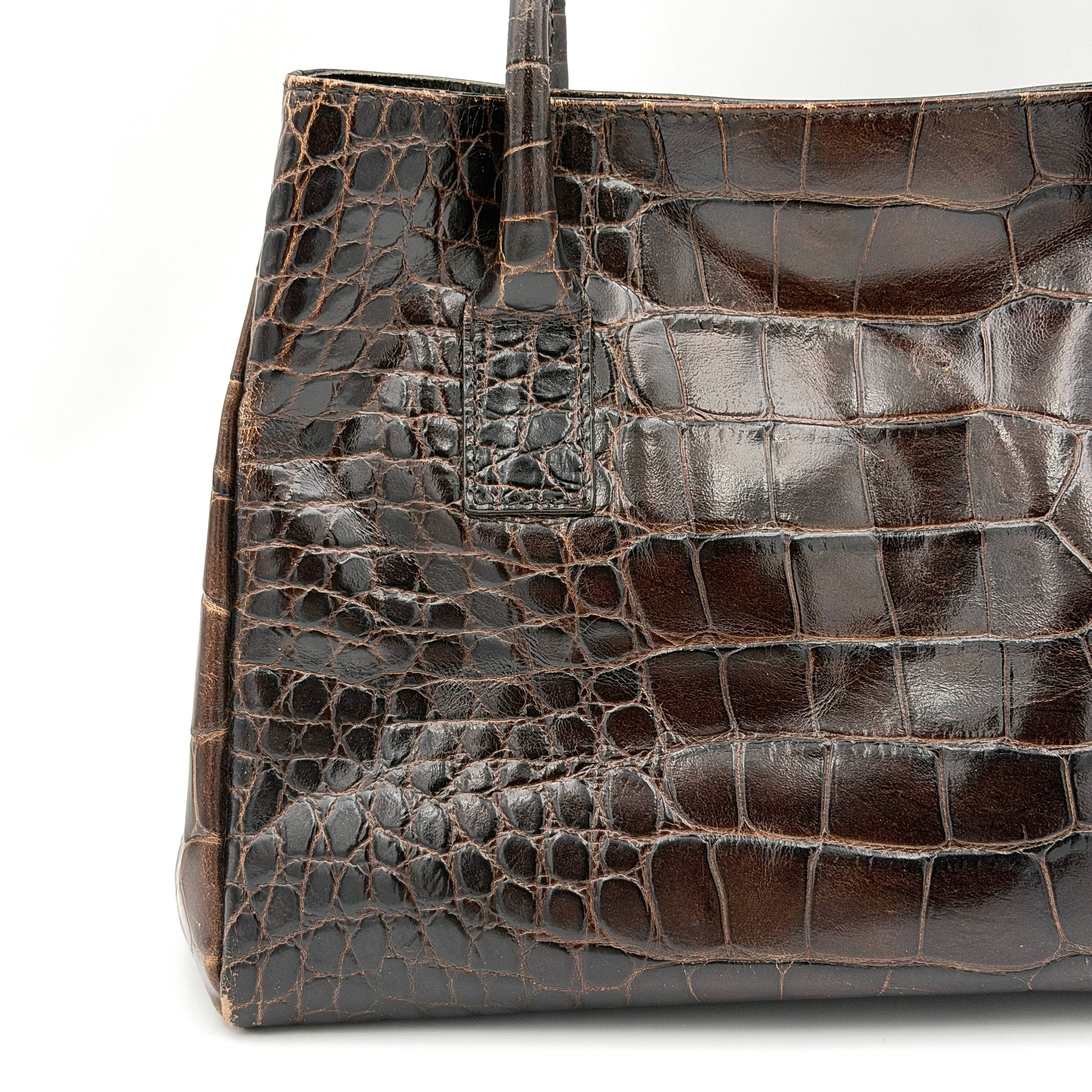 Furla croc-embossed dark brown leather handbag with structured silhouette, dual top handles, and silver turn-lock closure.
