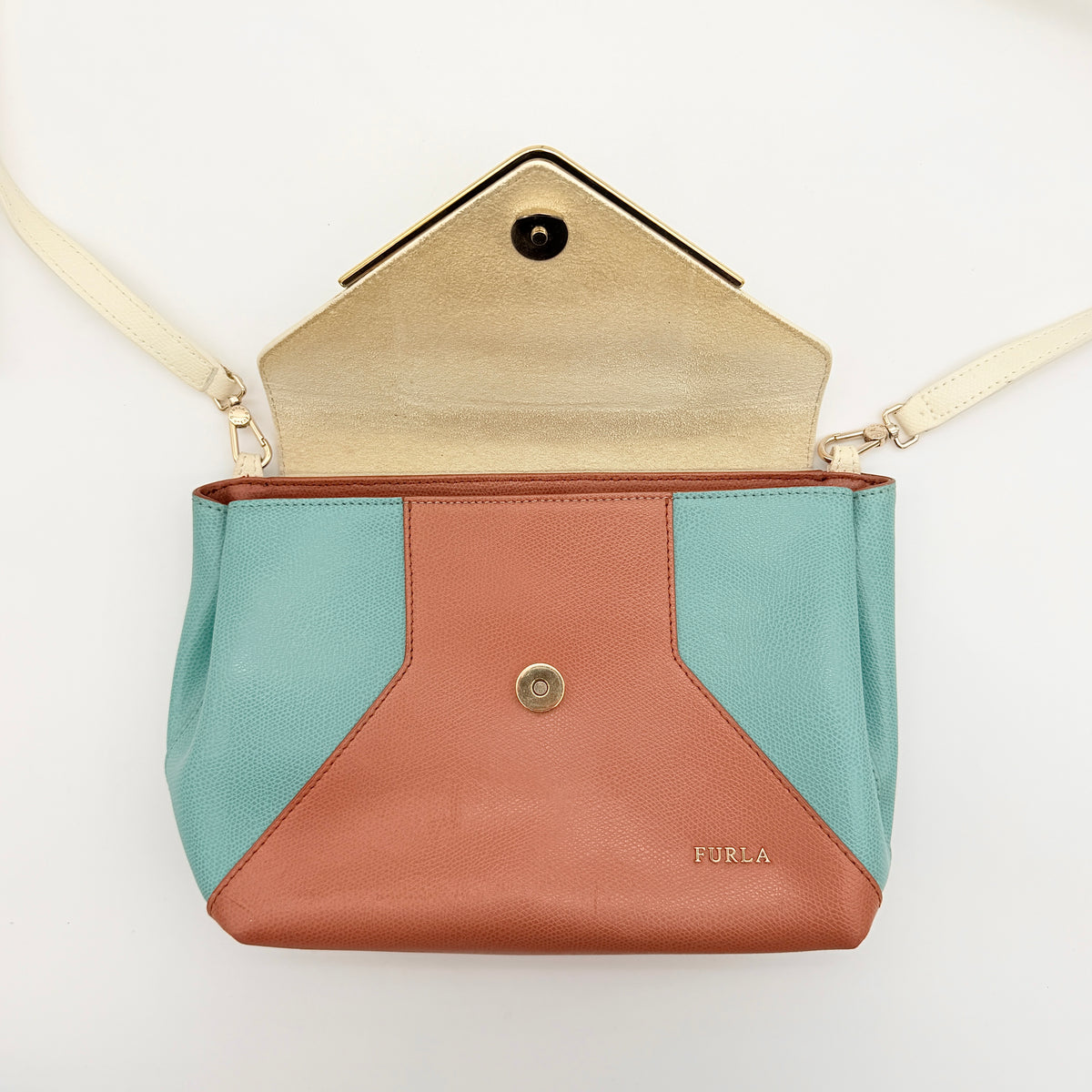 Furla Kelis crossbody bag in brown, blue, and cream leather with envelope flap and gold-tone hardware, displayed on a Furla dust bag.