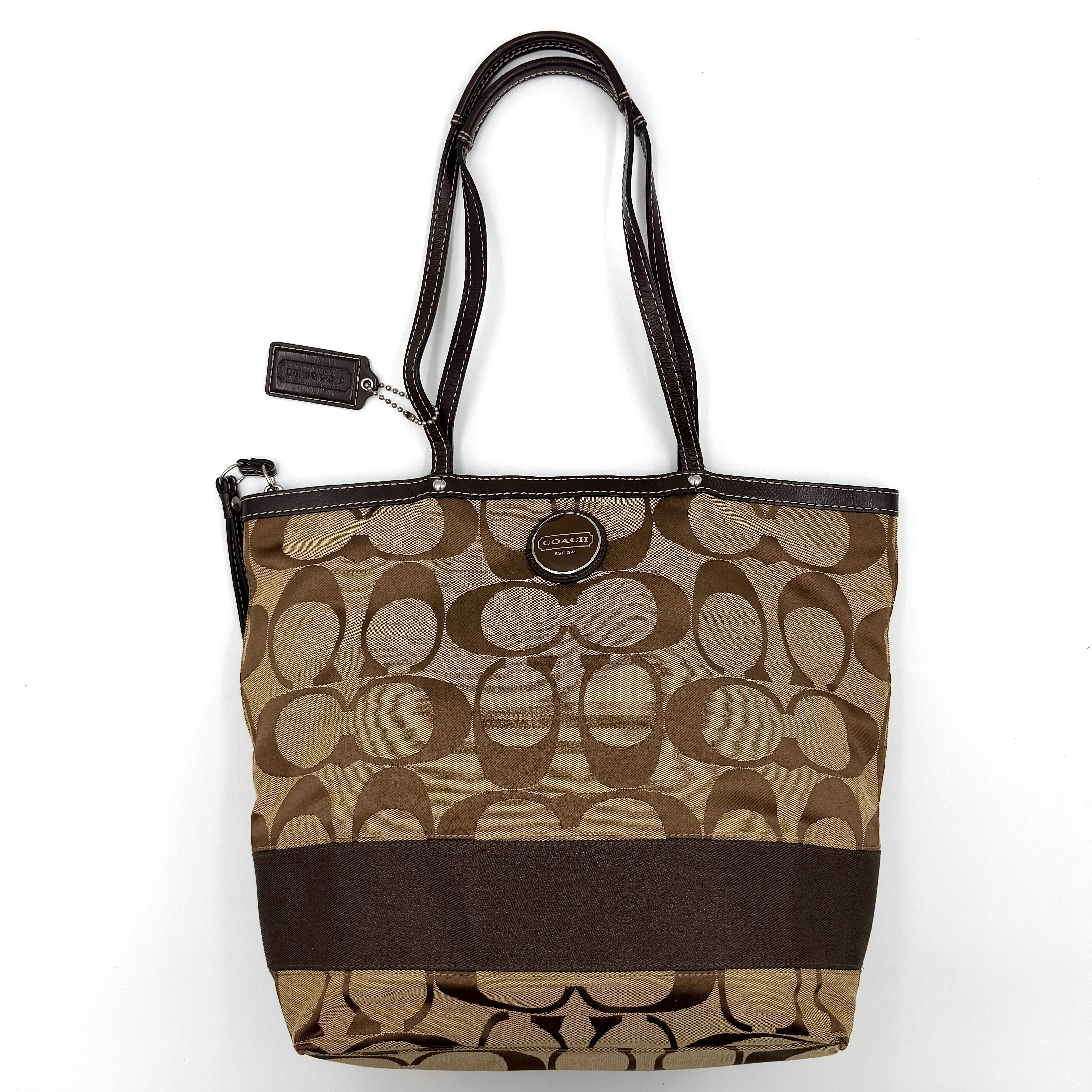 Coach Signature Stripe Tote Bag in brown and beige monogram canvas with chocolate stripe and leather handles, photographed upright.