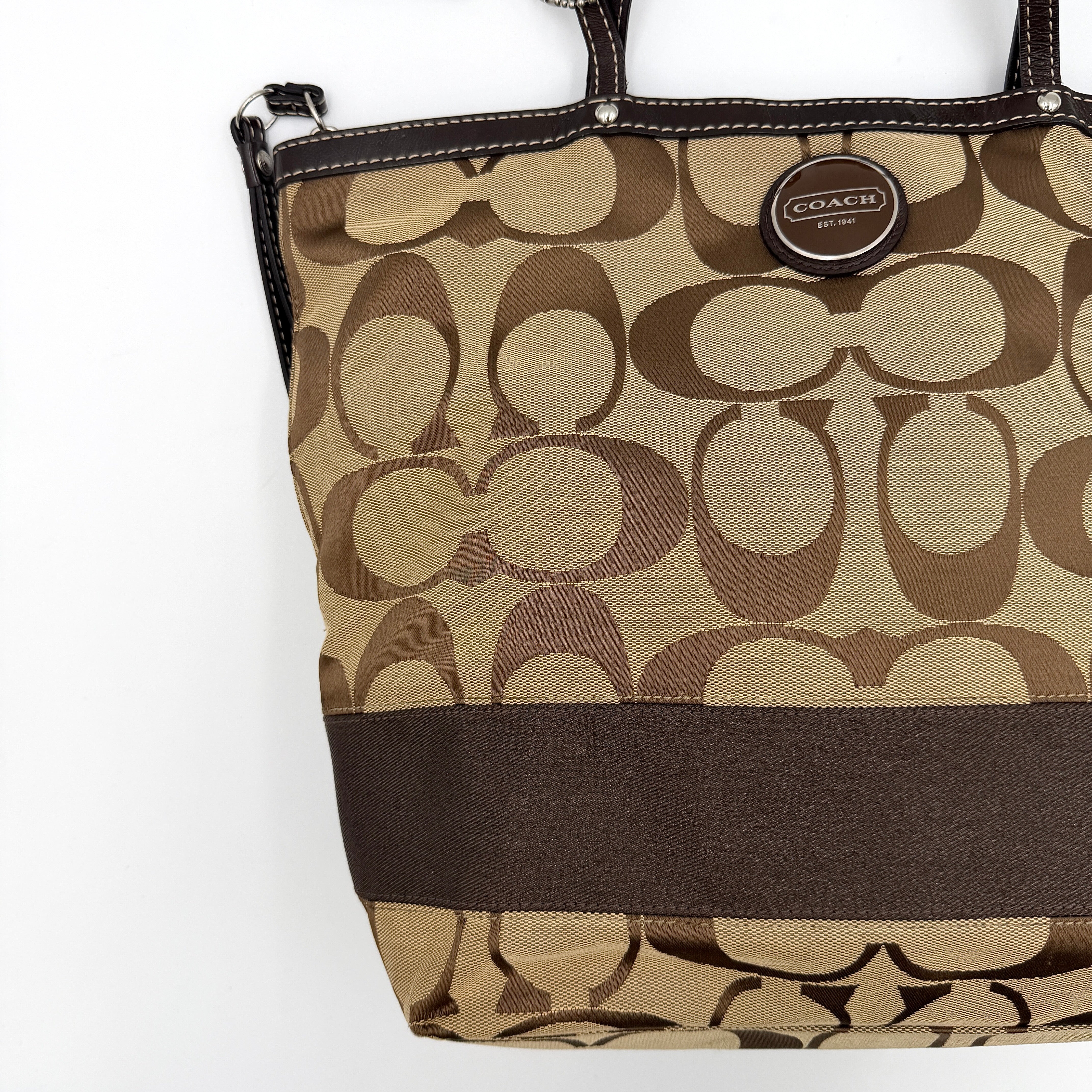 Coach Signature Stripe Tote Bag in brown and beige monogram canvas with chocolate stripe and leather handles, photographed upright.