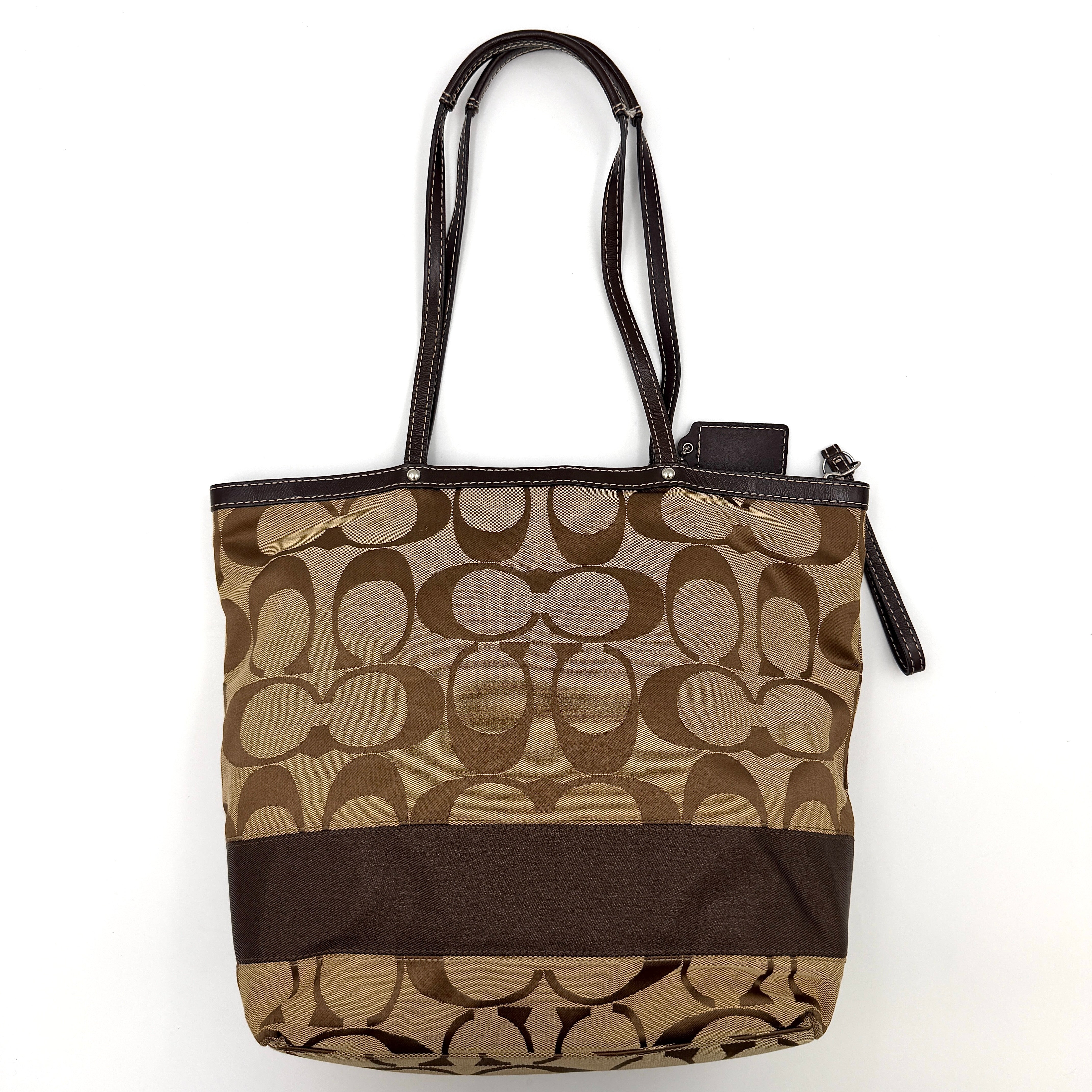 Coach Signature Stripe Tote Bag in brown and beige monogram canvas with chocolate stripe and leather handles, photographed upright.
