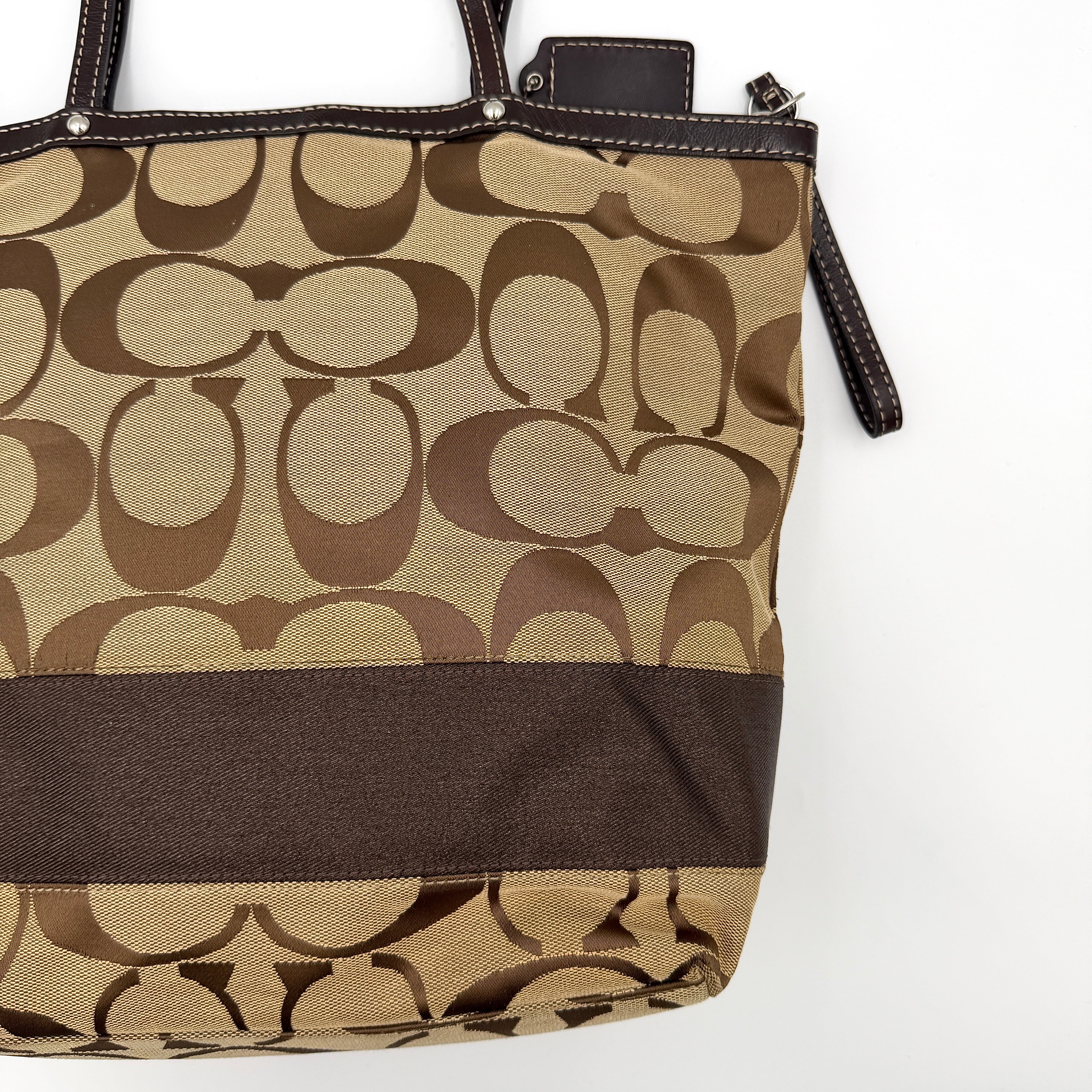 Coach Signature Stripe Tote Bag in brown and beige monogram canvas with chocolate stripe and leather handles, photographed upright.