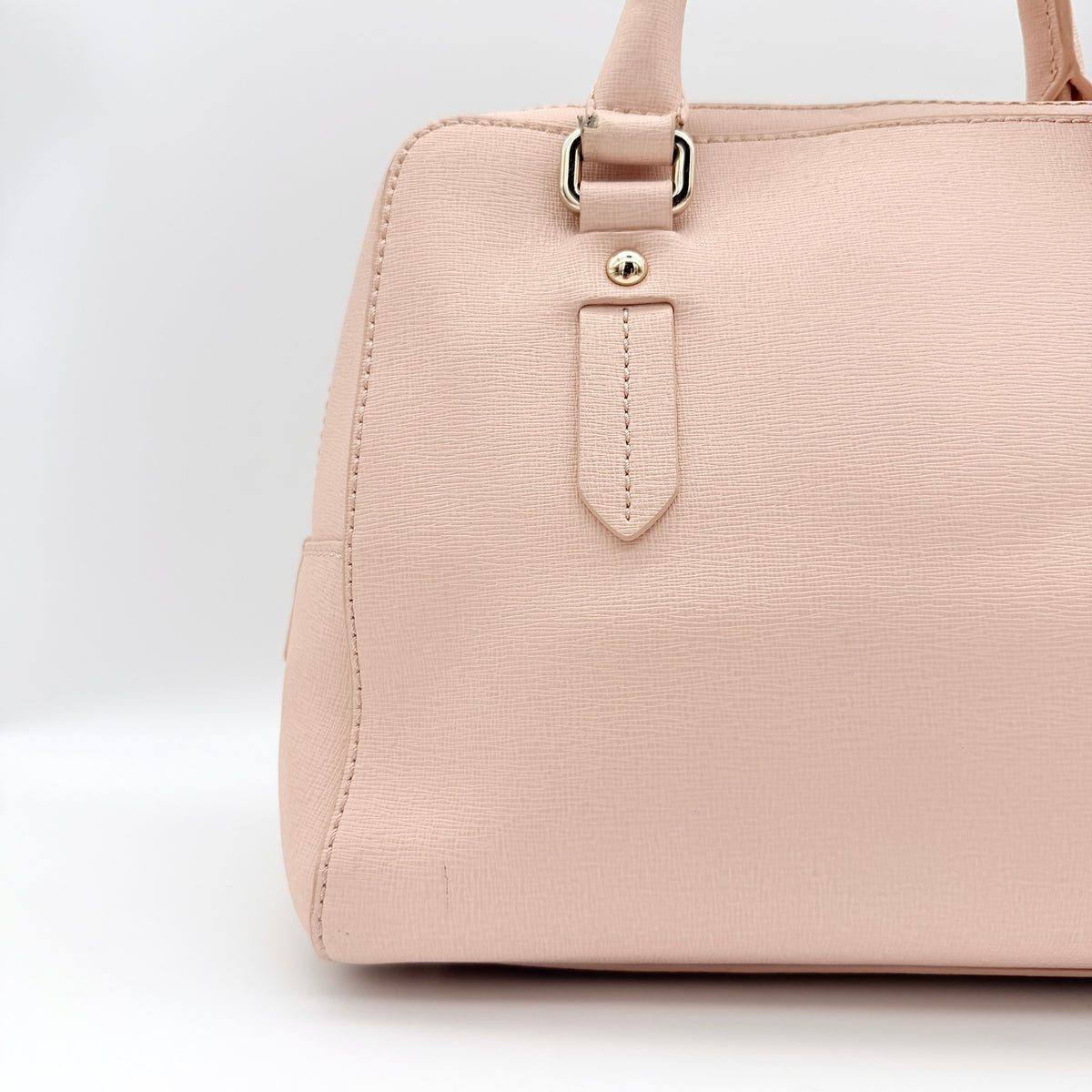 Furla Elena 2Way Saffiano leather satchel in beige with gold-tone hardware and removable strap, displayed on Furla-branded dust bag.