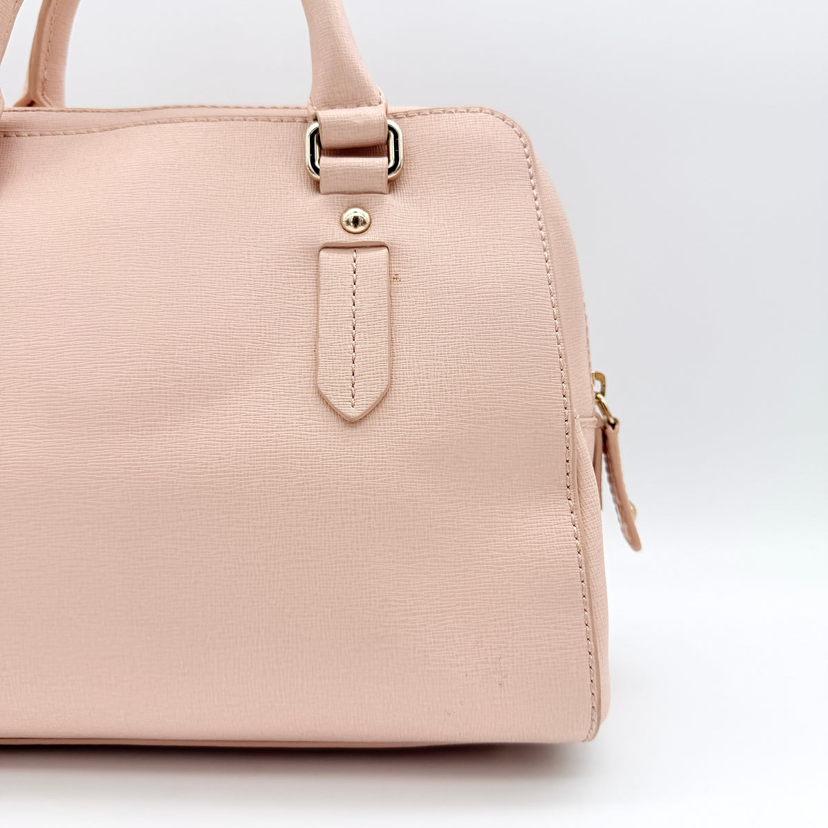 Furla Elena 2Way Saffiano leather satchel in beige with gold-tone hardware and removable strap, displayed on Furla-branded dust bag.