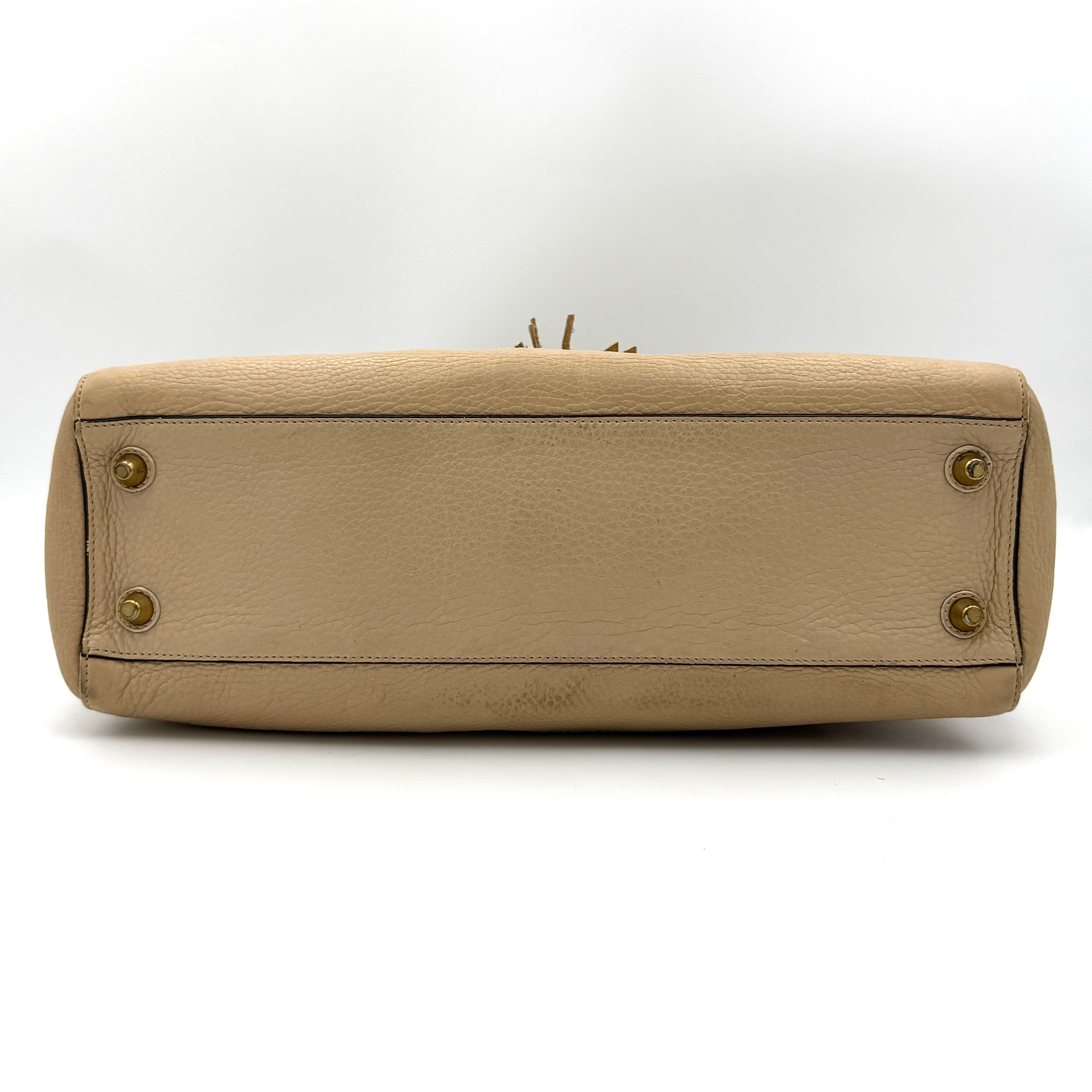 Coach beige Hampton Carryall Shoulder Bag with braided leather details, gold hardware, and tassel accent, displayed front-facing.