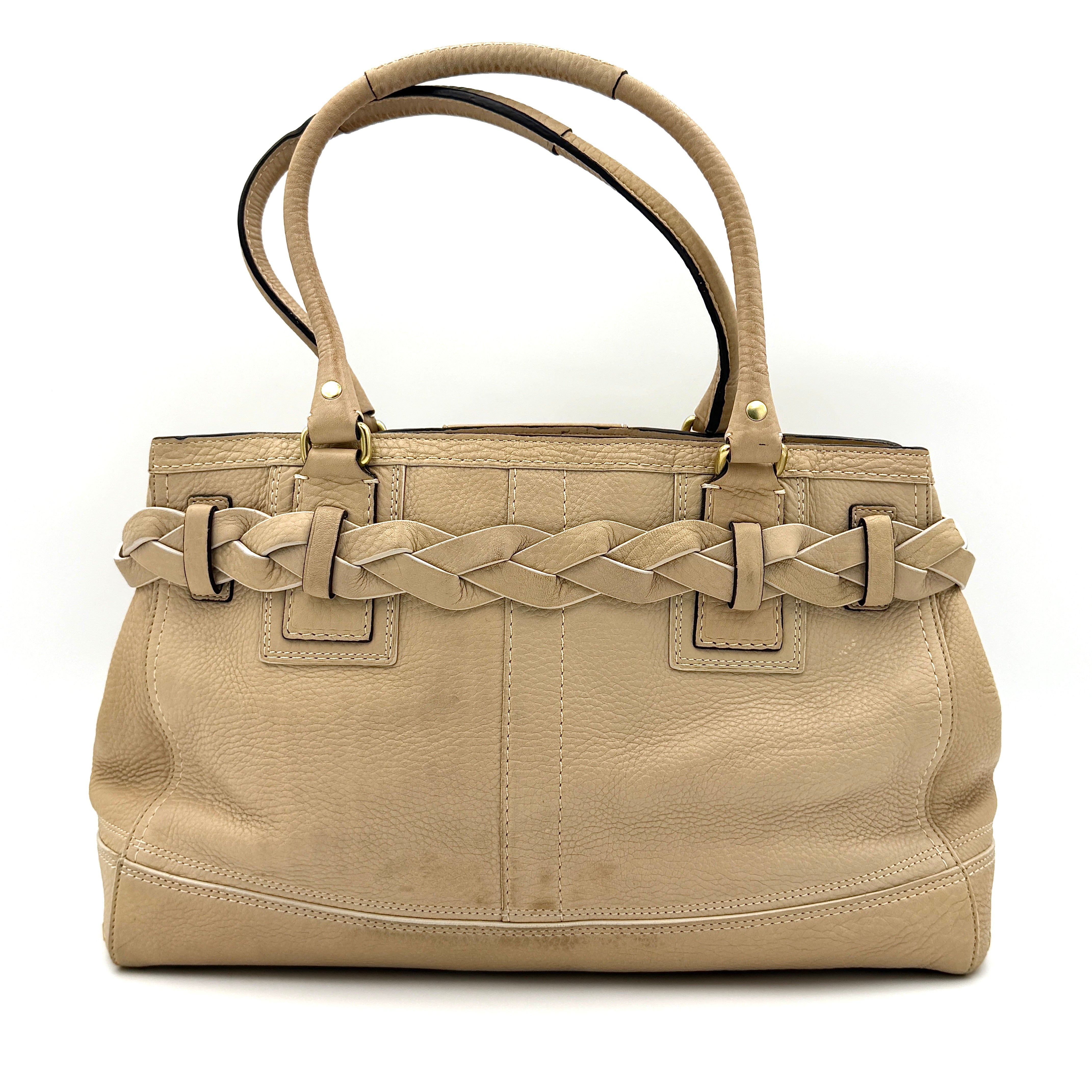 Coach beige Hampton Carryall Shoulder Bag with braided leather details, gold hardware, and tassel accent, displayed front-facing.
