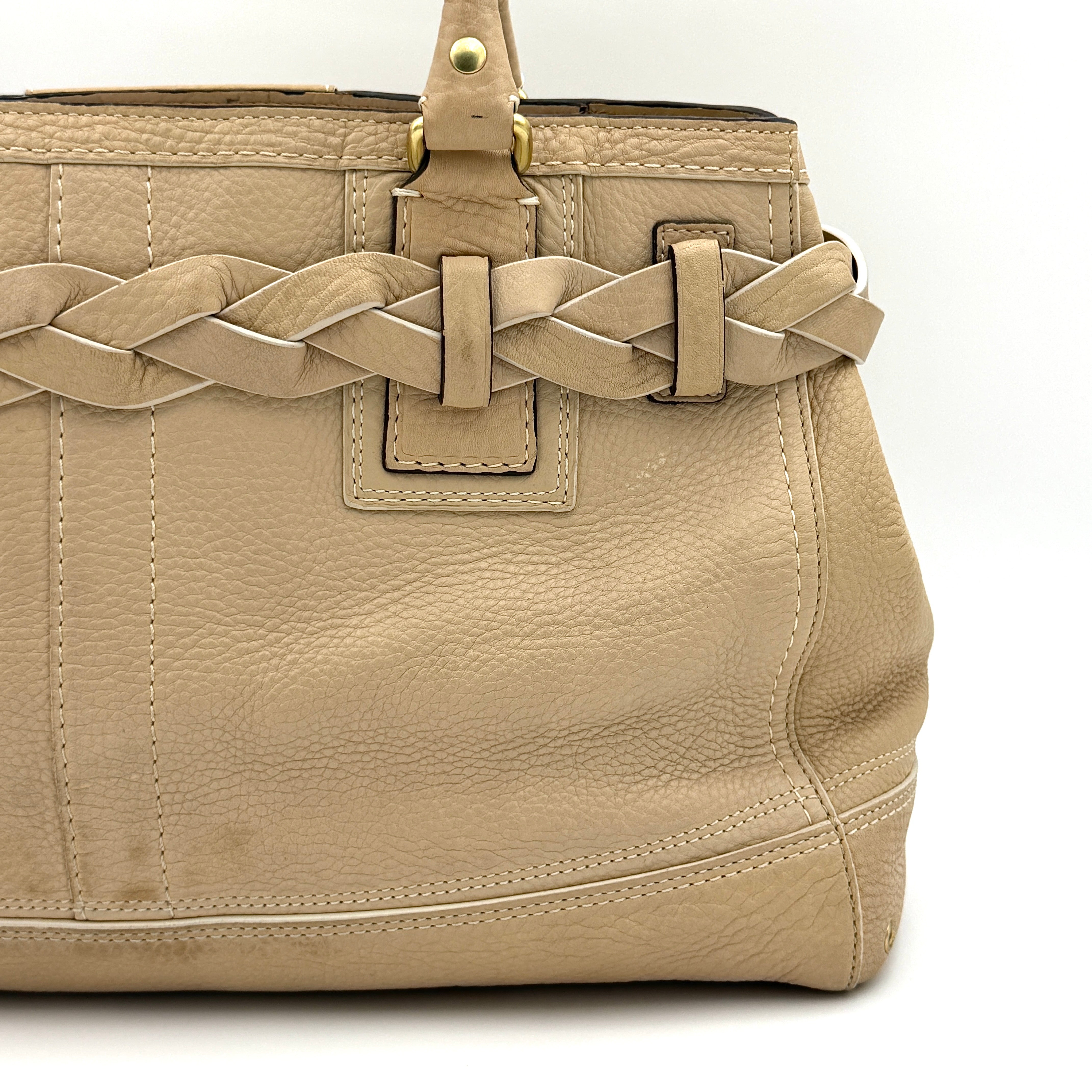 Coach beige Hampton Carryall Shoulder Bag with braided leather details, gold hardware, and tassel accent, displayed front-facing.