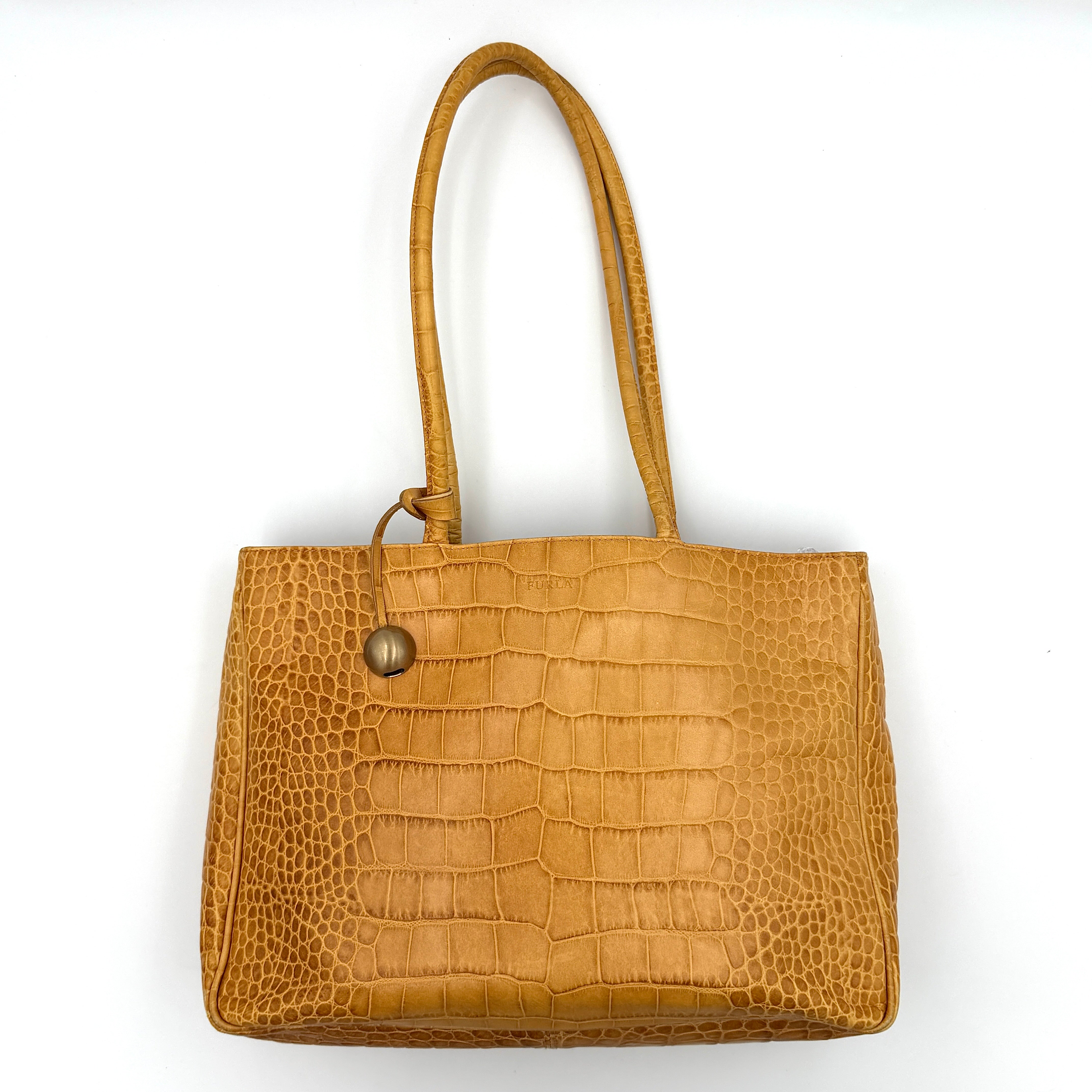 Furla yellow croc-embossed leather tote bag with double handles and matte gold logo charm, presented against a white background.