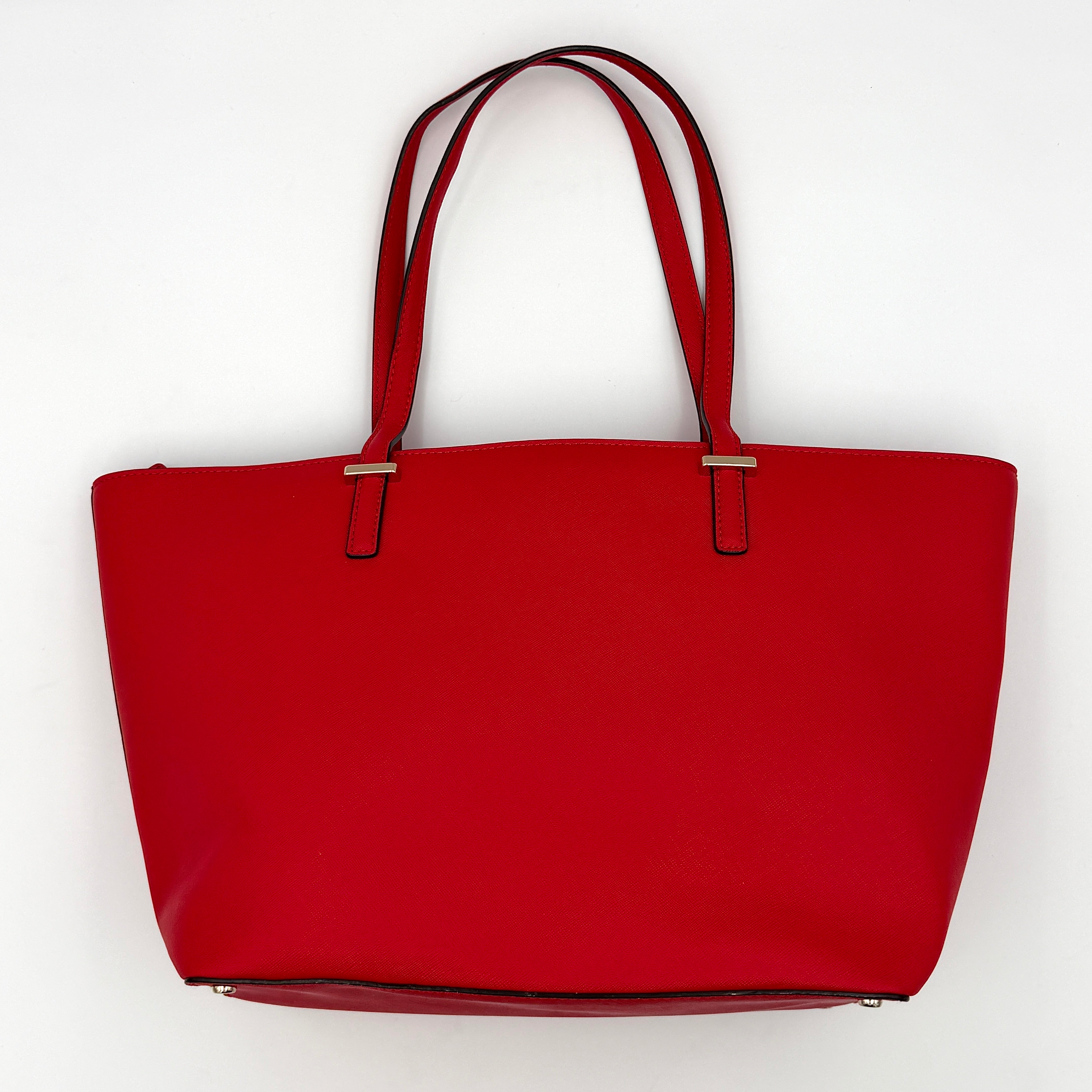 Kate Spade Cedar Street Harmony Tote bag in bold red saffiano leather, featuring dual top handles and gold-tone details.
