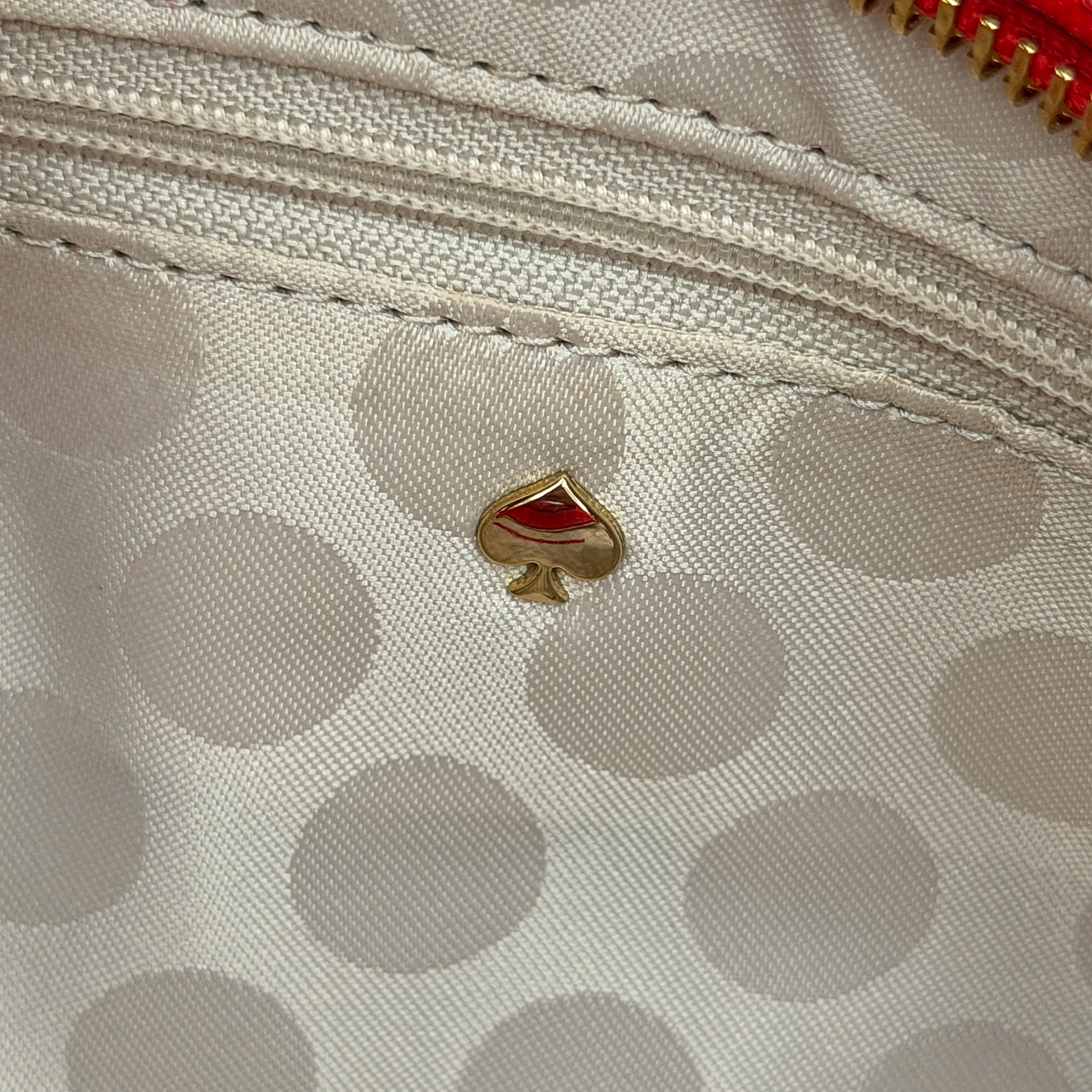 Kate Spade Cedar Street Harmony Tote bag in bold red saffiano leather, featuring dual top handles and gold-tone details.