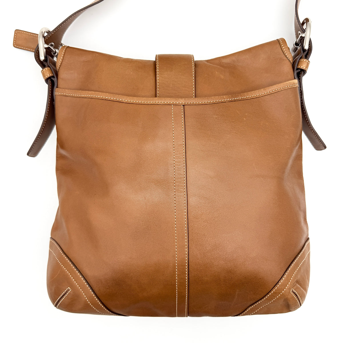 Coach Soho Buckle Flap Crossbody Bag in brown leather with buckle flap and adjustable strap, displayed on white background.
