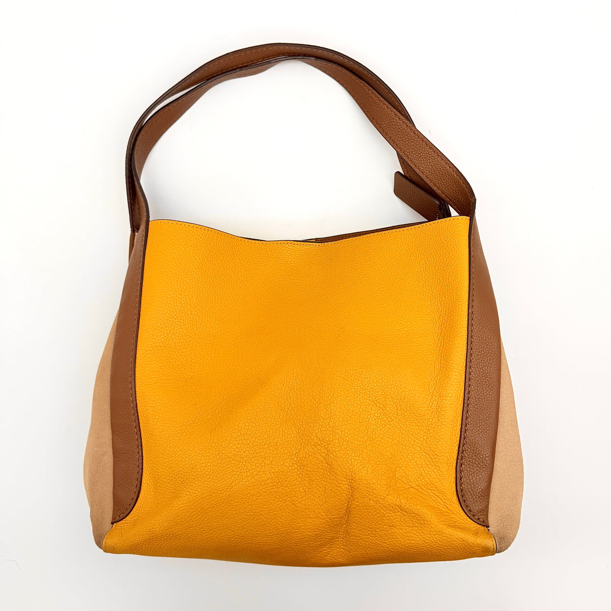 Coach Hadley Colorblock Hobo bag in yellow and brown leather with double top handles and suede side panels, shown against a white background.